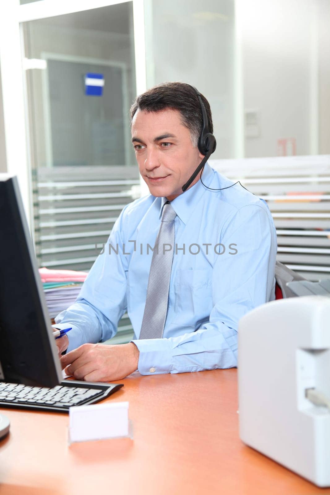 Adult man in the office talking on the phone