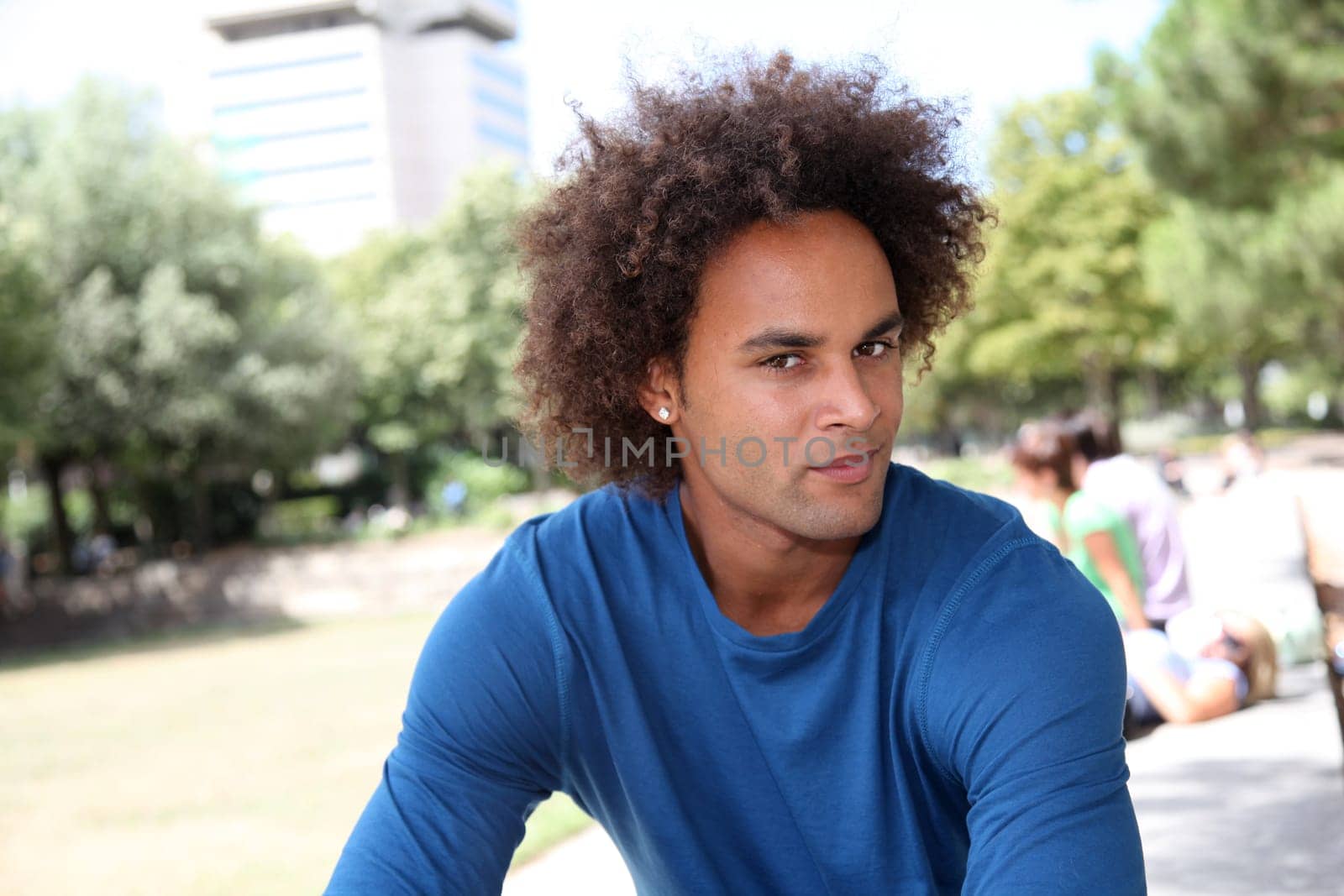 Closeup of young man sitting in a park