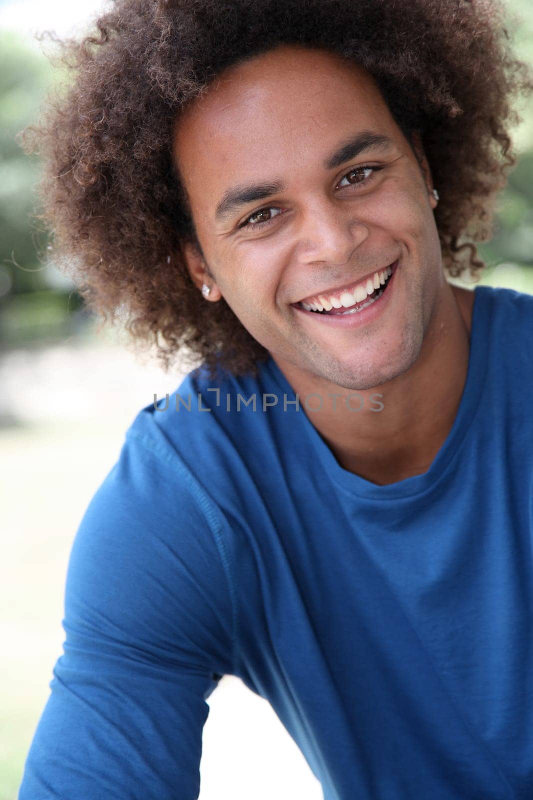 Closeup of happy young man with blue shirt