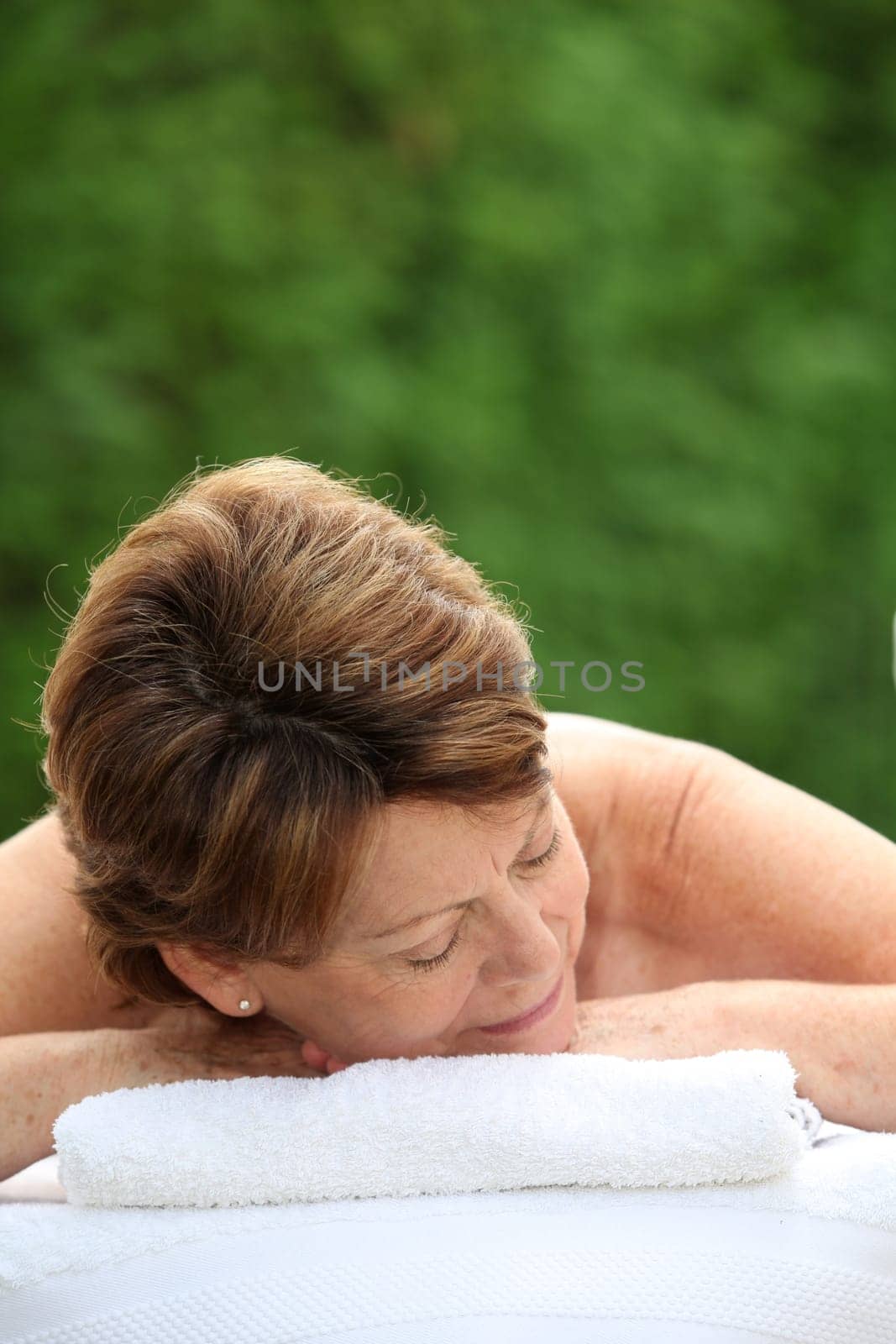 Senior woman on a massage bed