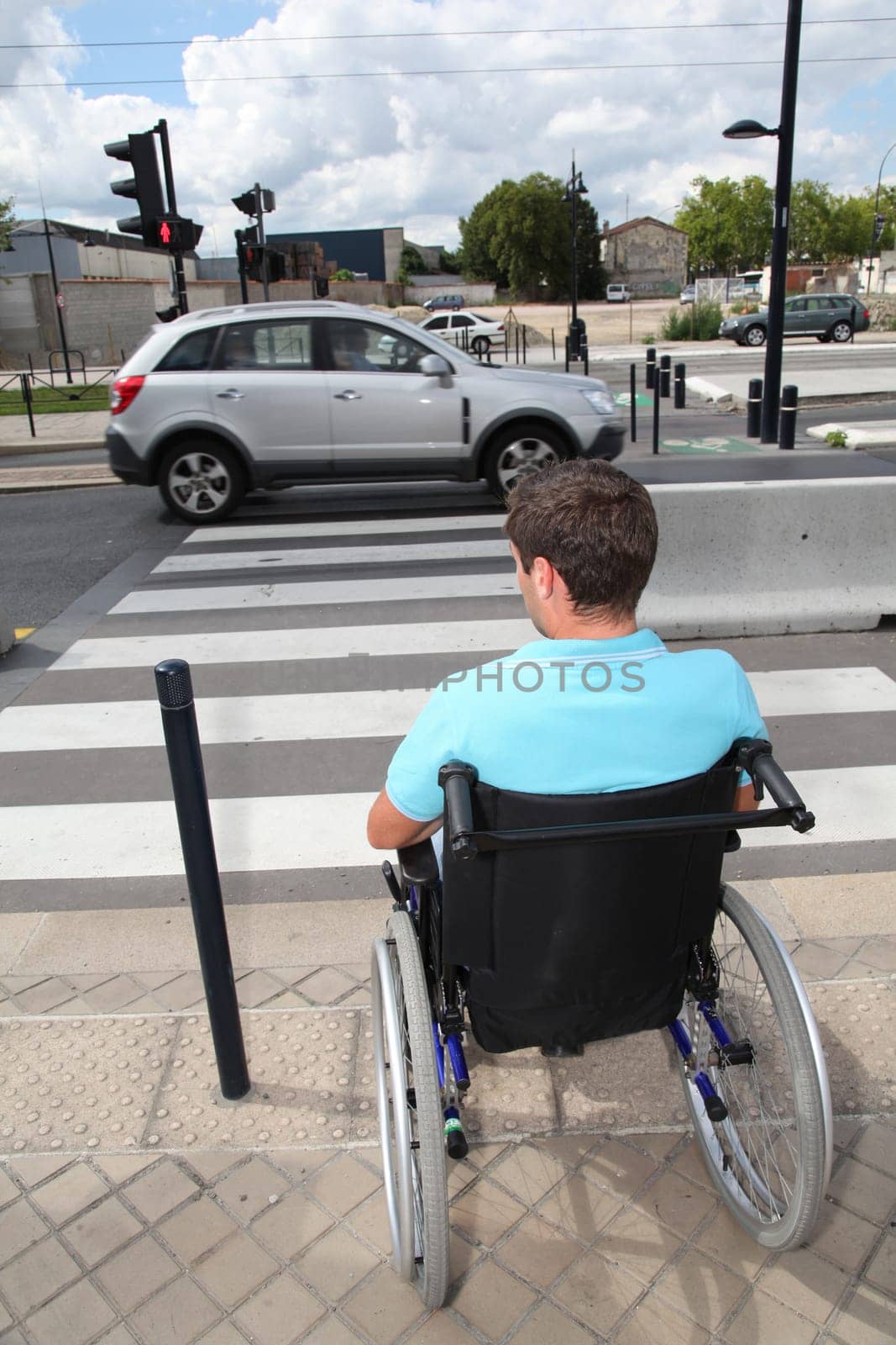 Young man using wheelchair in town