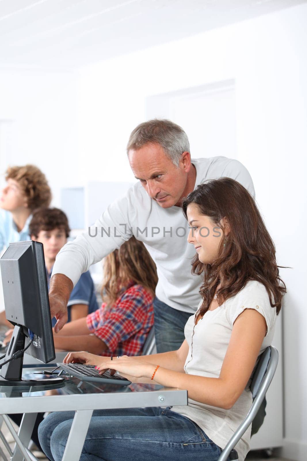 Teacher with student in classoom