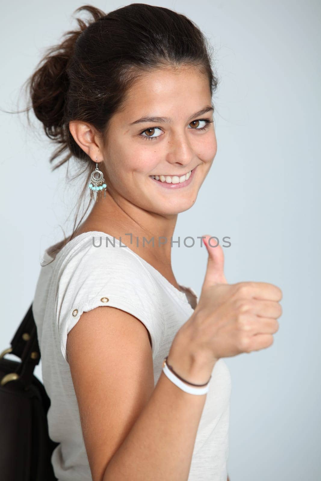 Closeup of teenaged girl wth thumb up