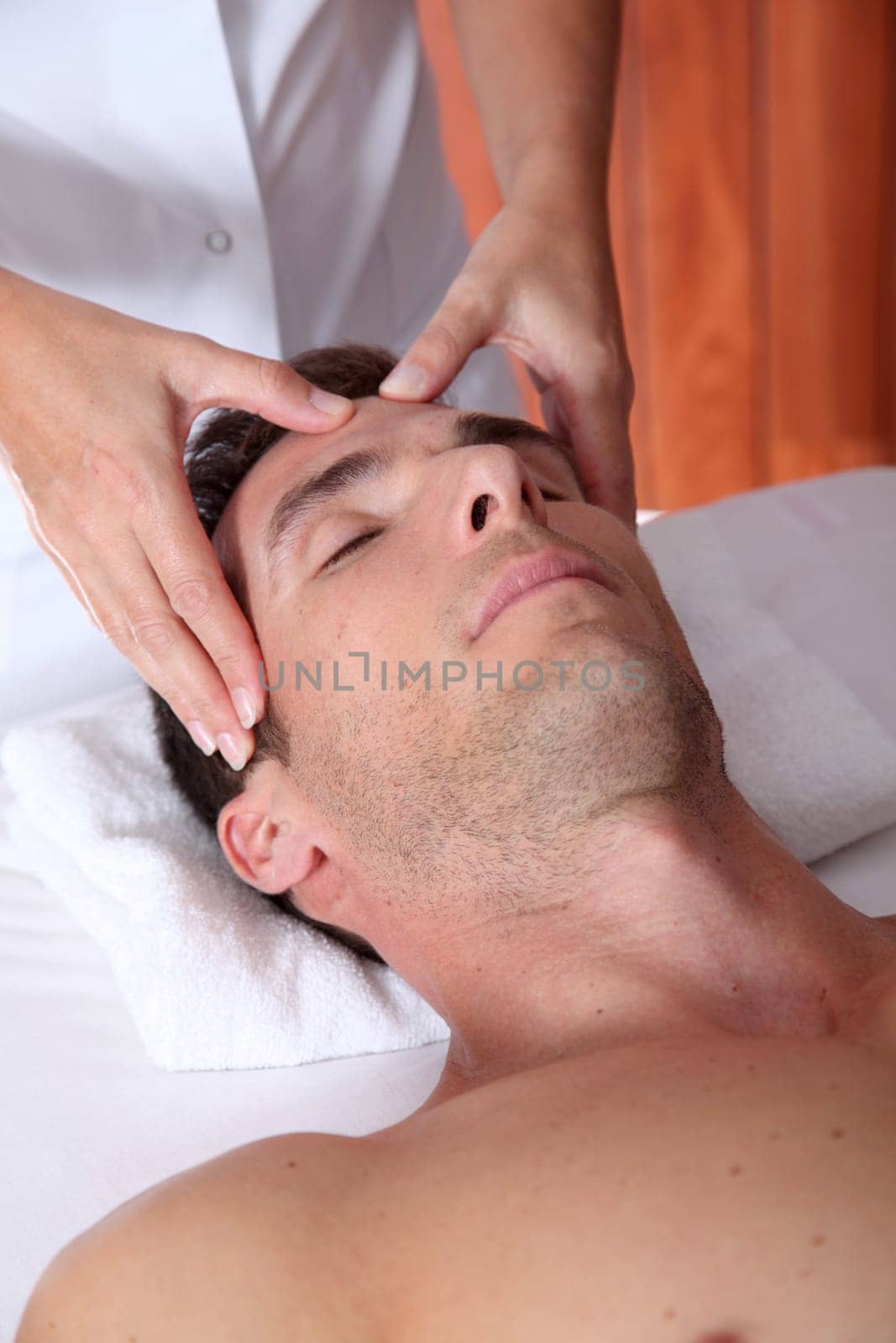 Man having a facial massage in spa center