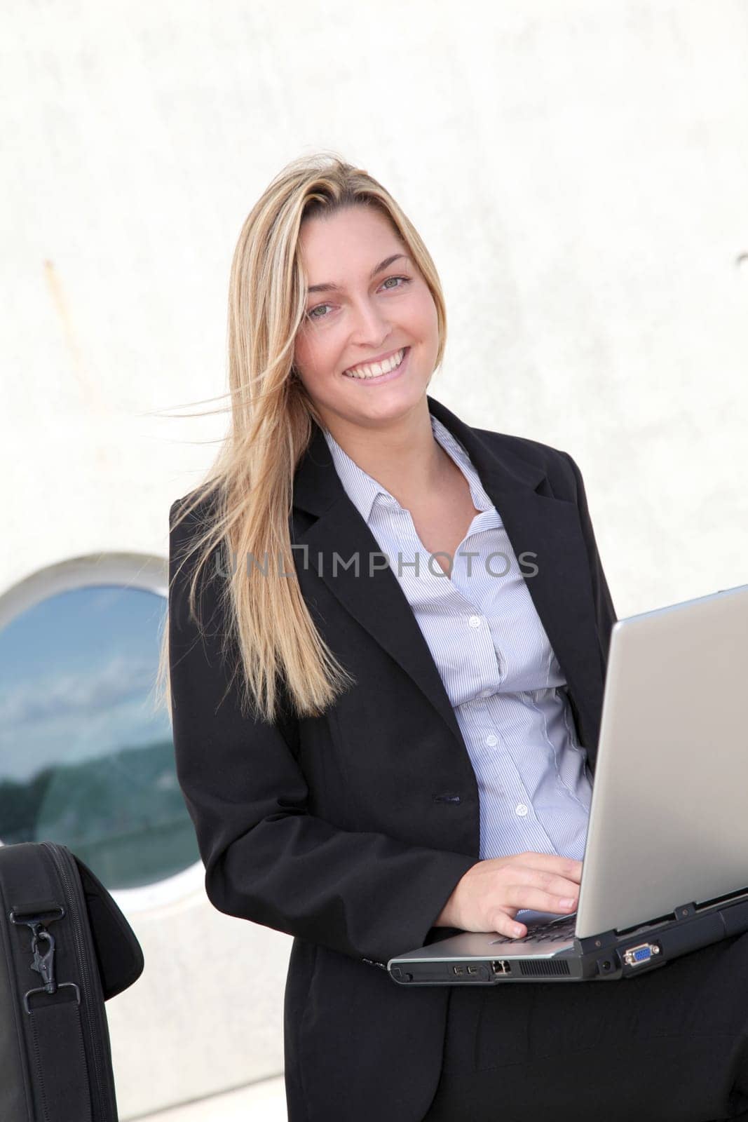 Closeup of smiling businesswoman with laptop computer