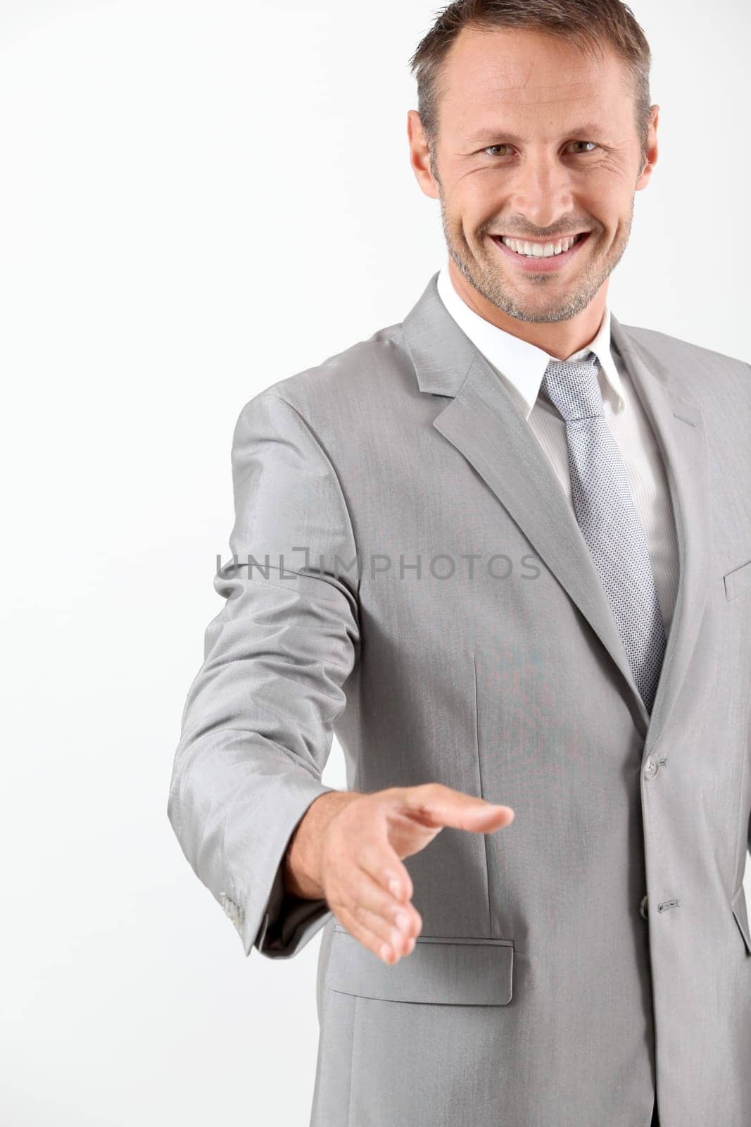 Businessman extending hand towards camera