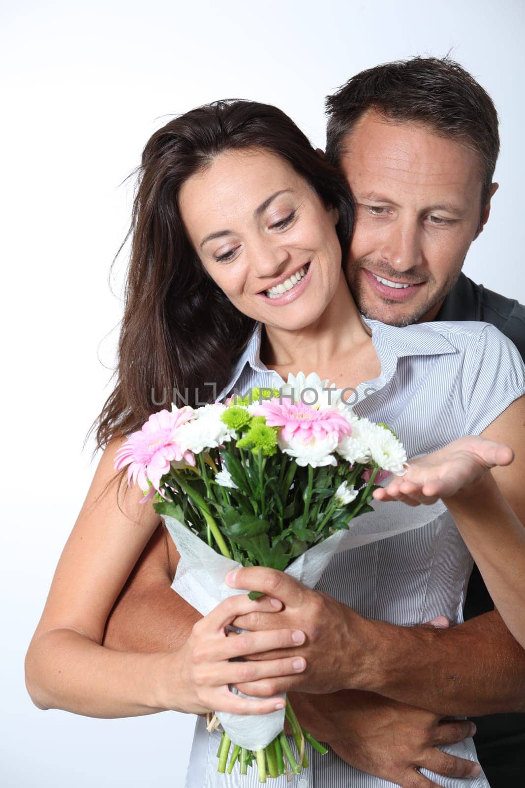 Man giving bunch of flowers to girlfriends