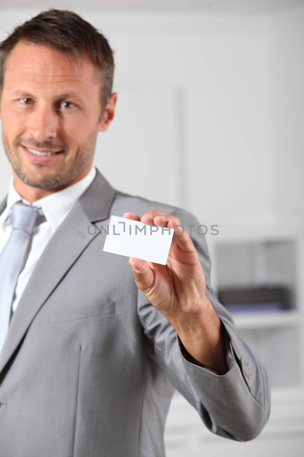 Businessman holding business card