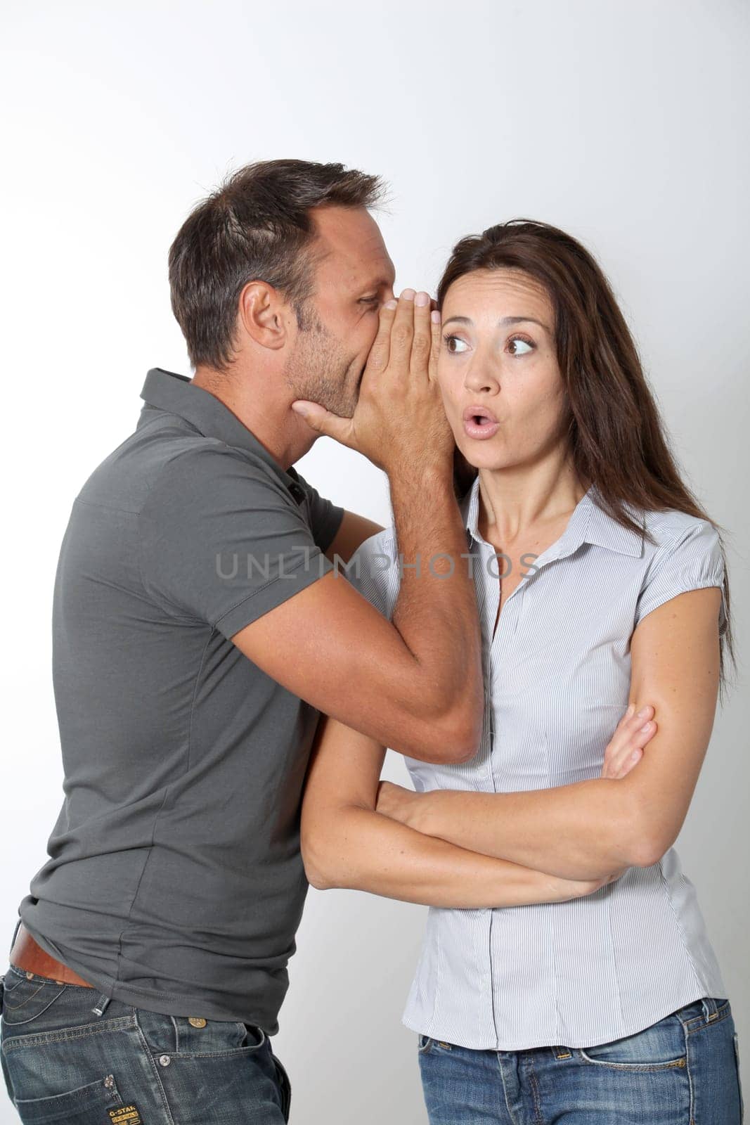 Man whispering to his girlfriend ear