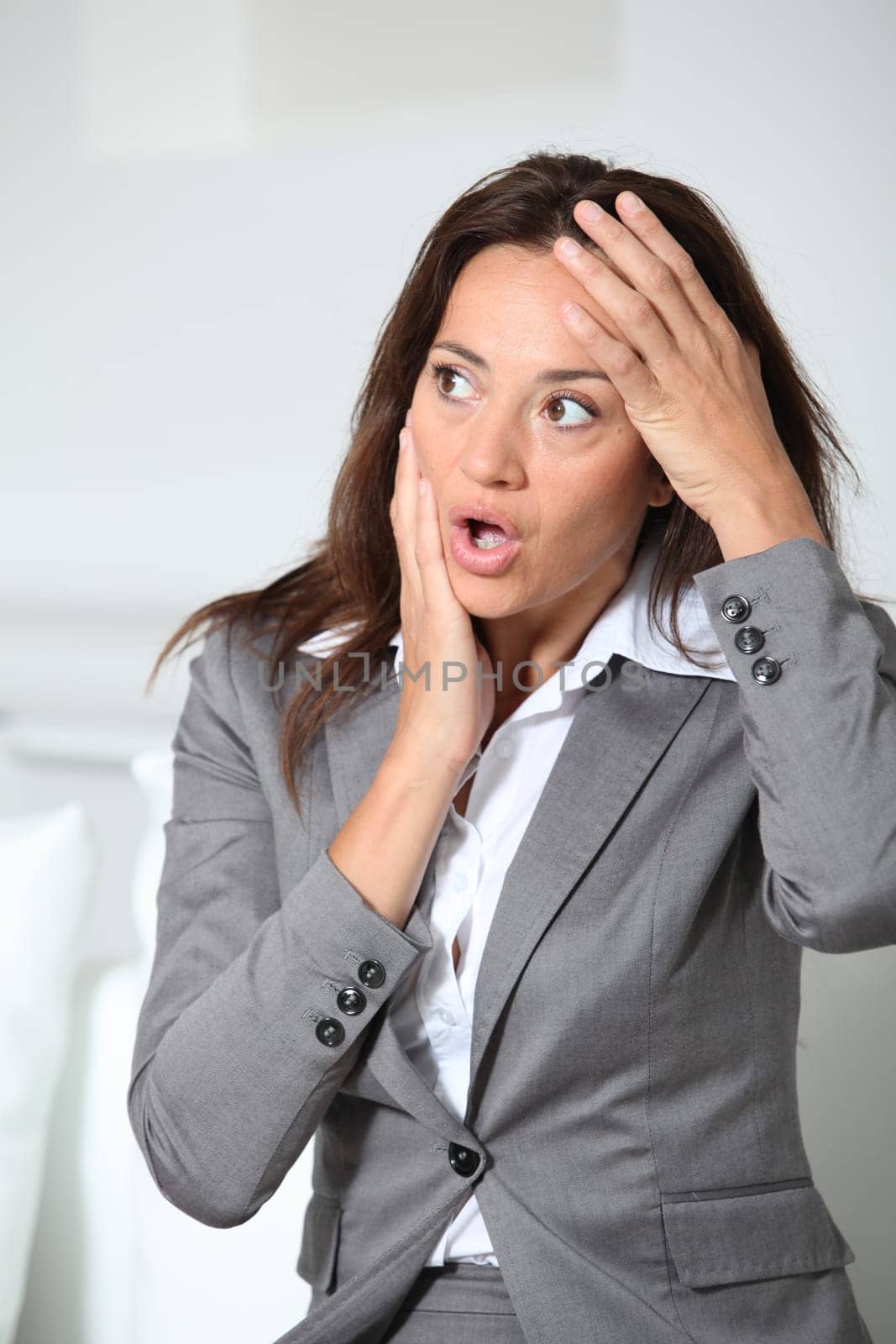 Businesswoman with hands on face