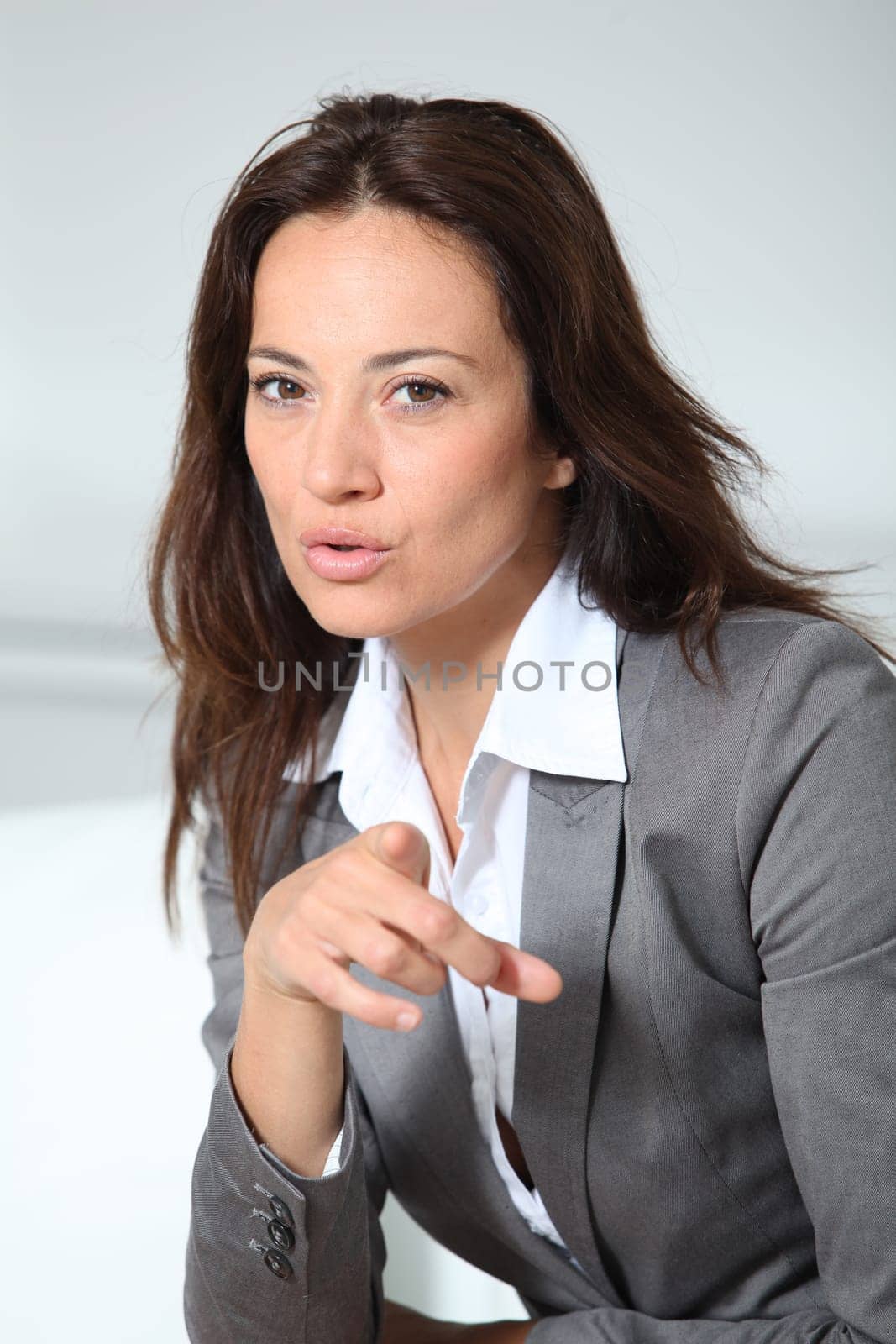 Businesswoman pointing at camera