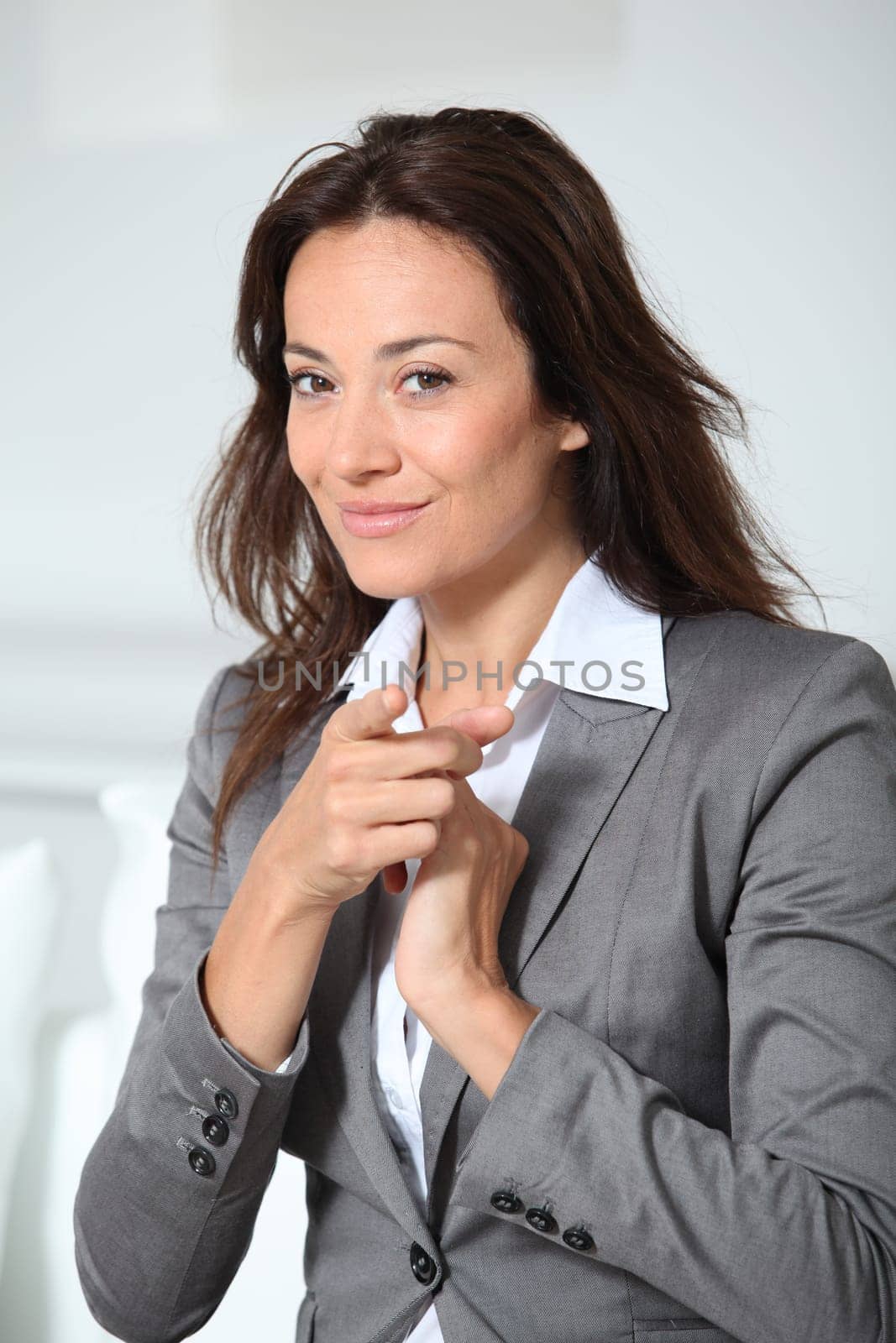 Businesswoman pointing at camera
