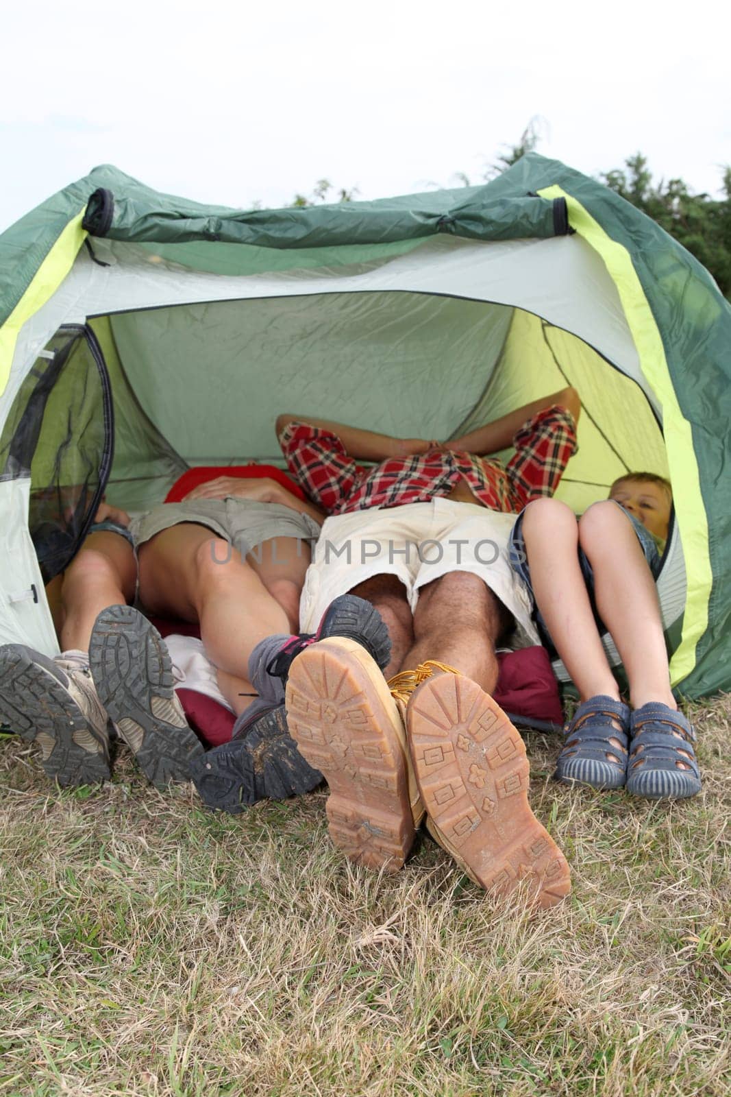 View of people feet from outside a camp tent