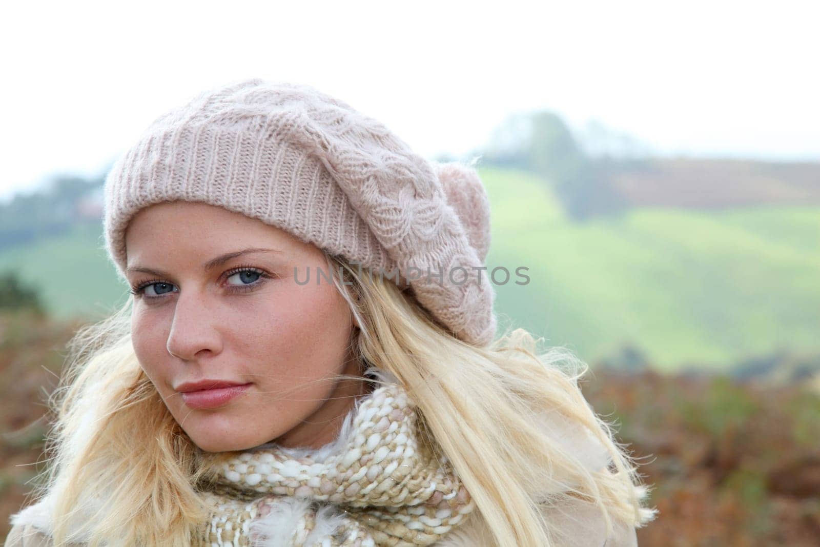 Blond woman wearing wool cap in autumn
