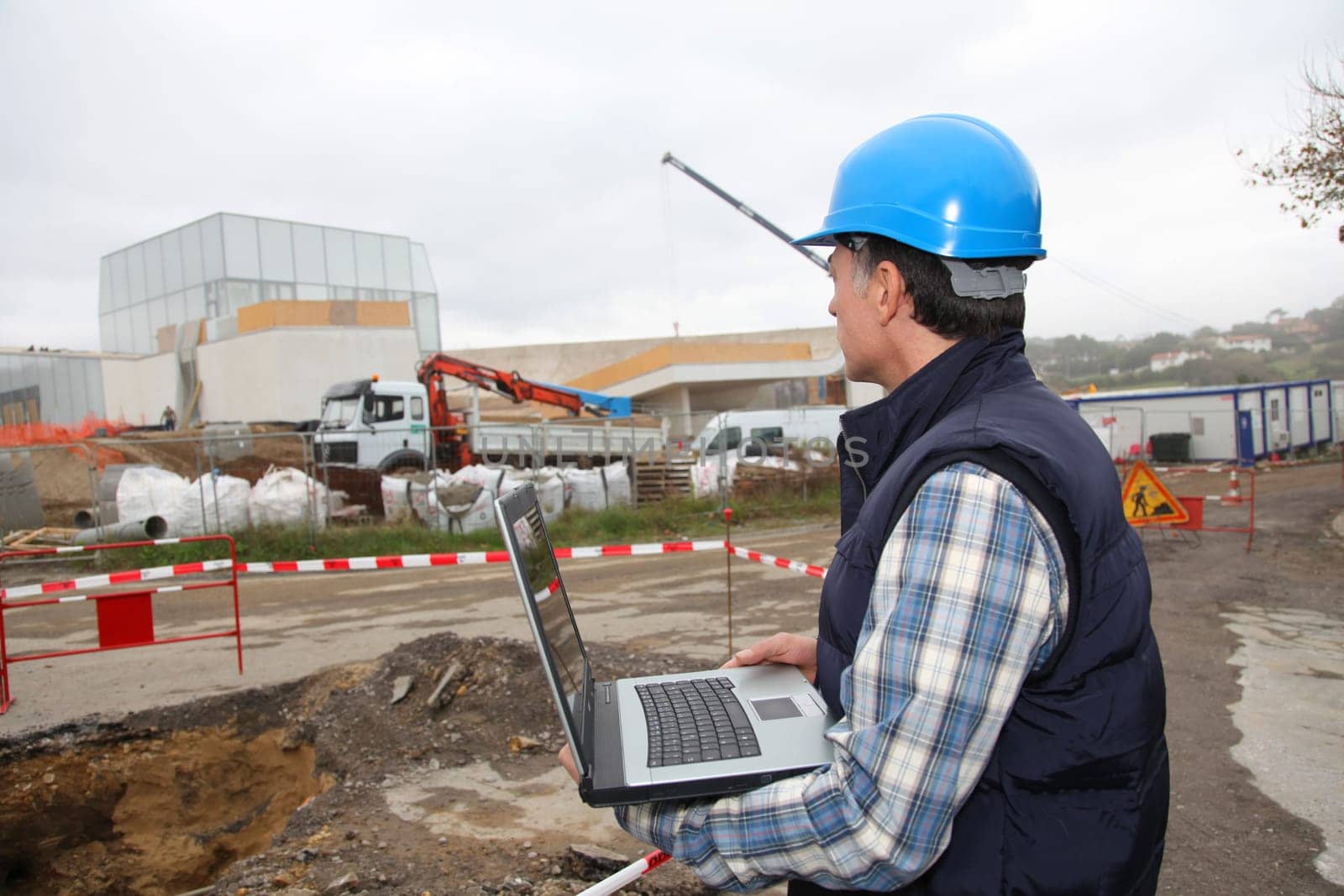 Engineer on construction site with laptop computer