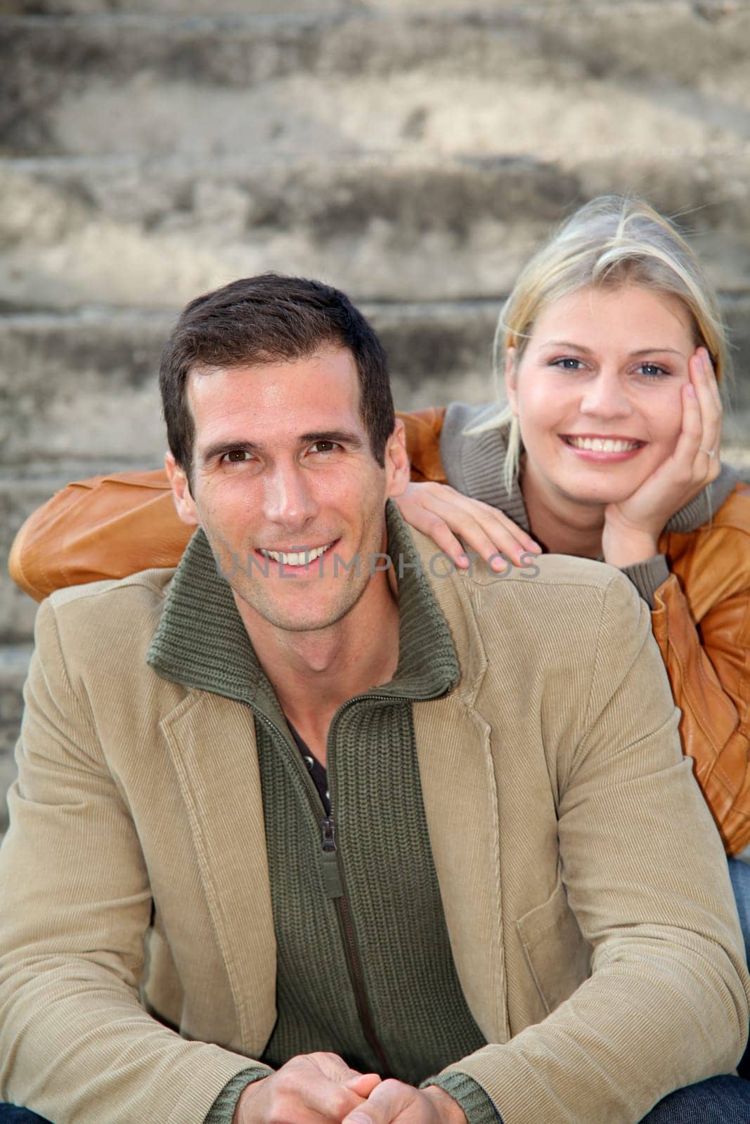 In loved couple sitting in staircase