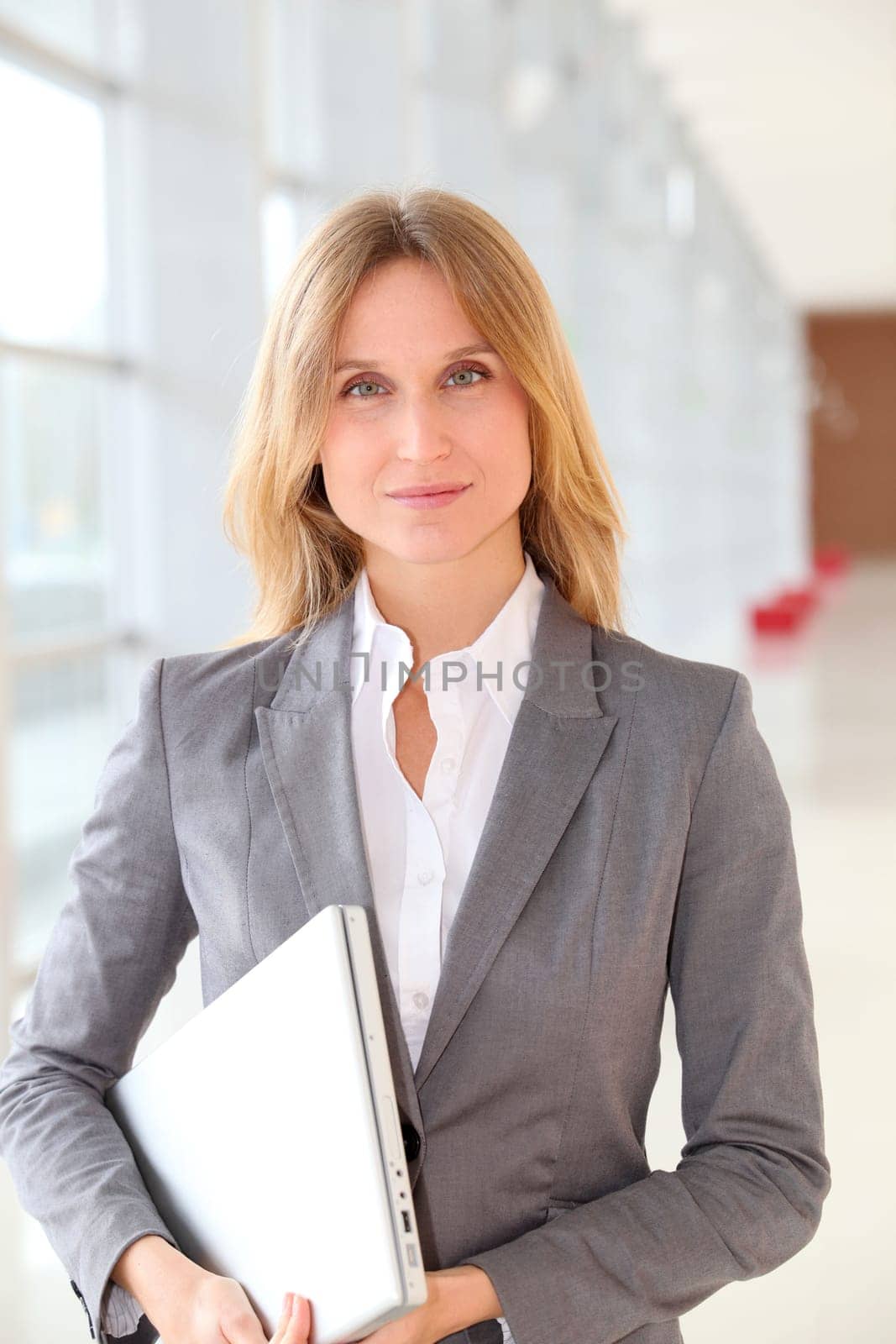 Closeup of blond businesswoman standing in hall