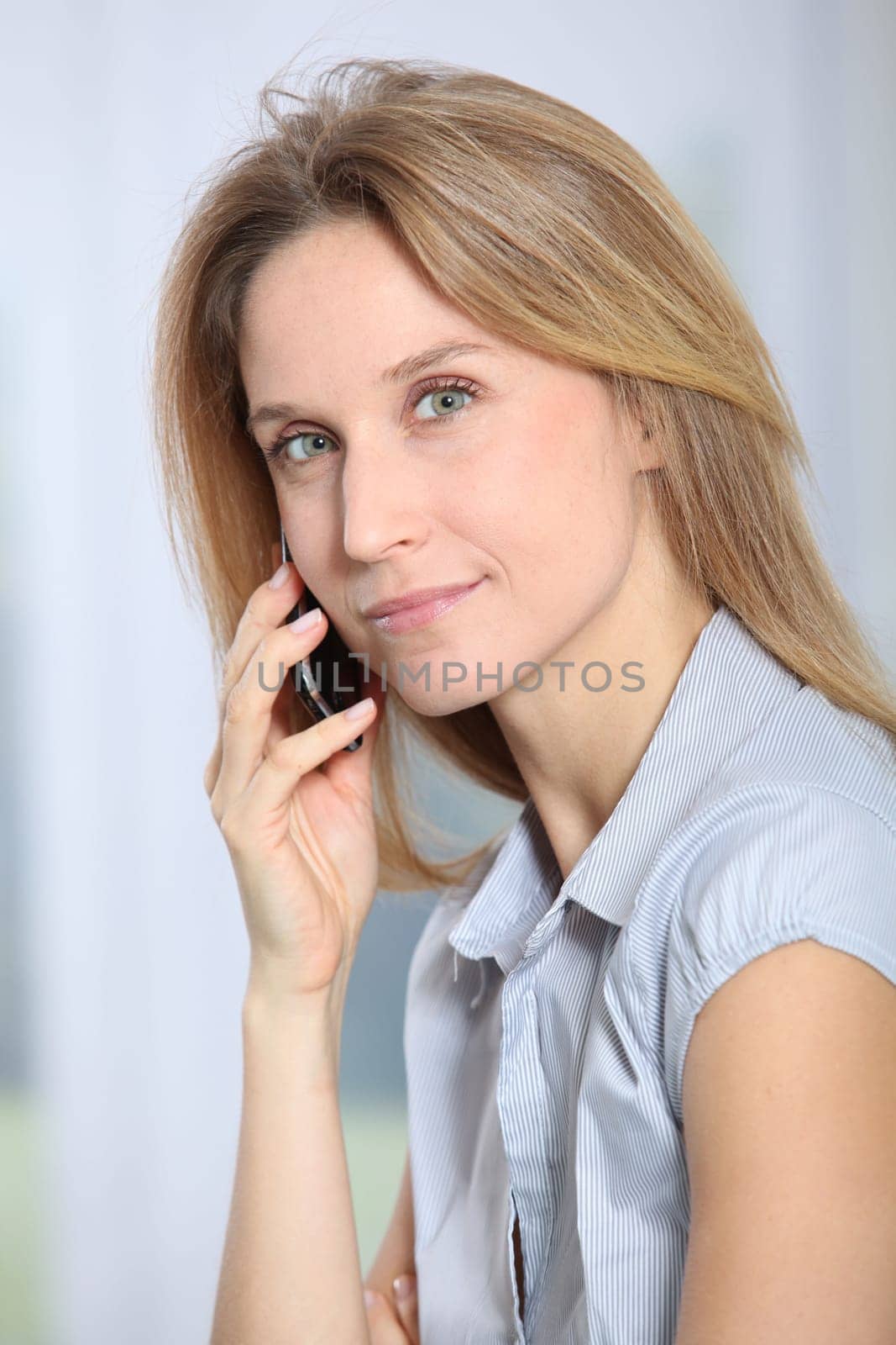 Closeup of beautiful office worker talking on the phone