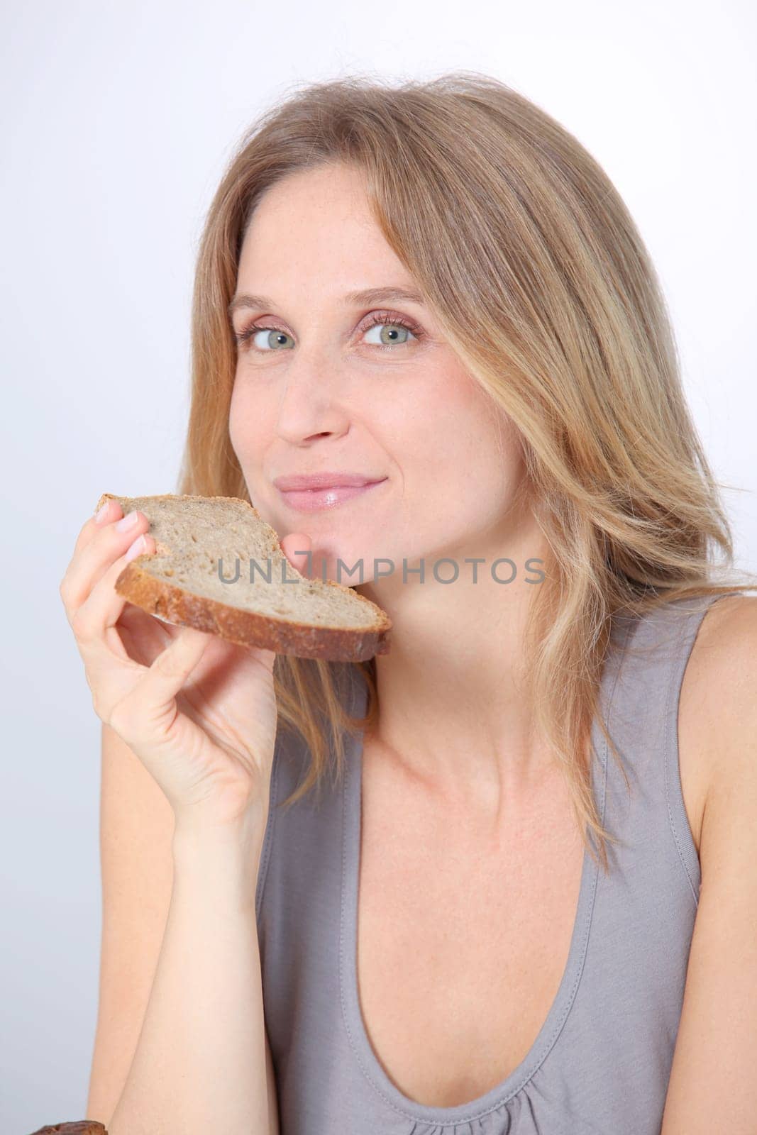 Closeup of beautiful woman eating slice of bread