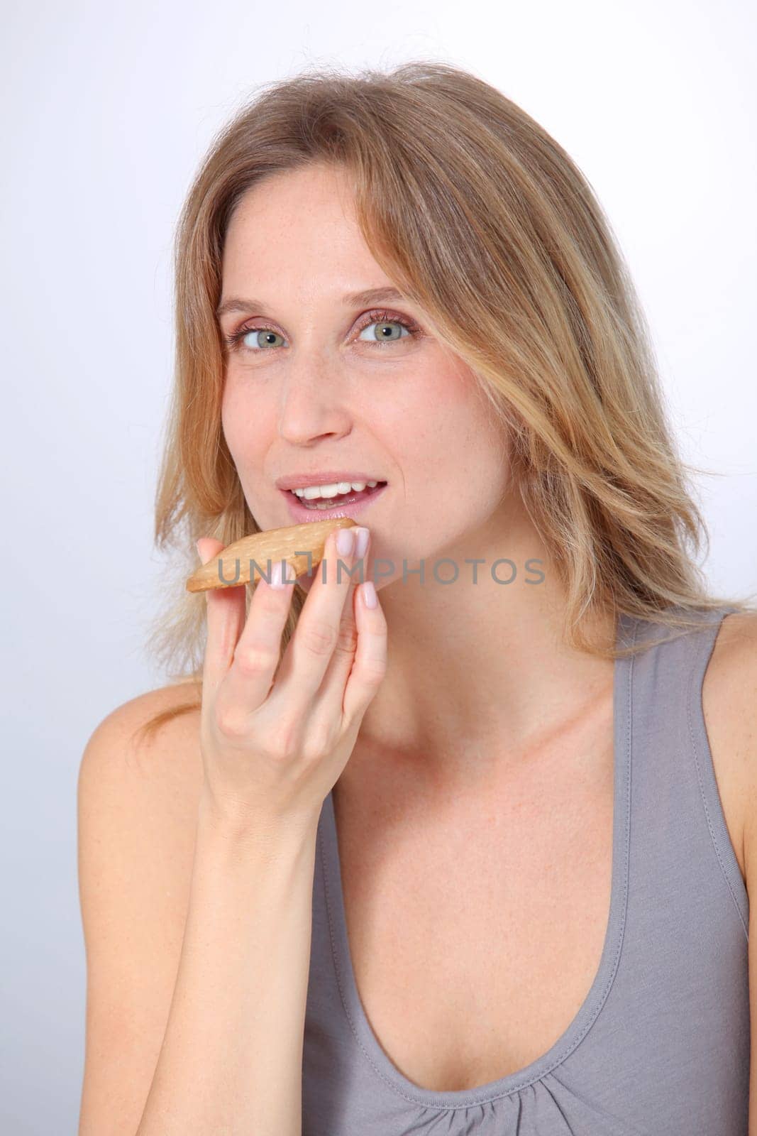 Closeup of woman eating cookie