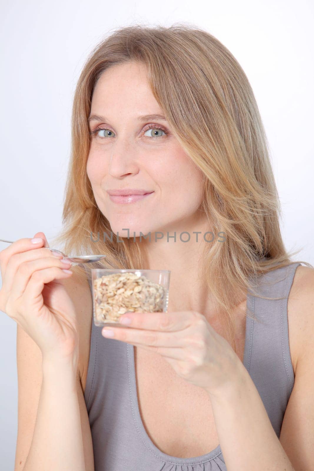 Closeup of beautiful blond woman eating cereals
