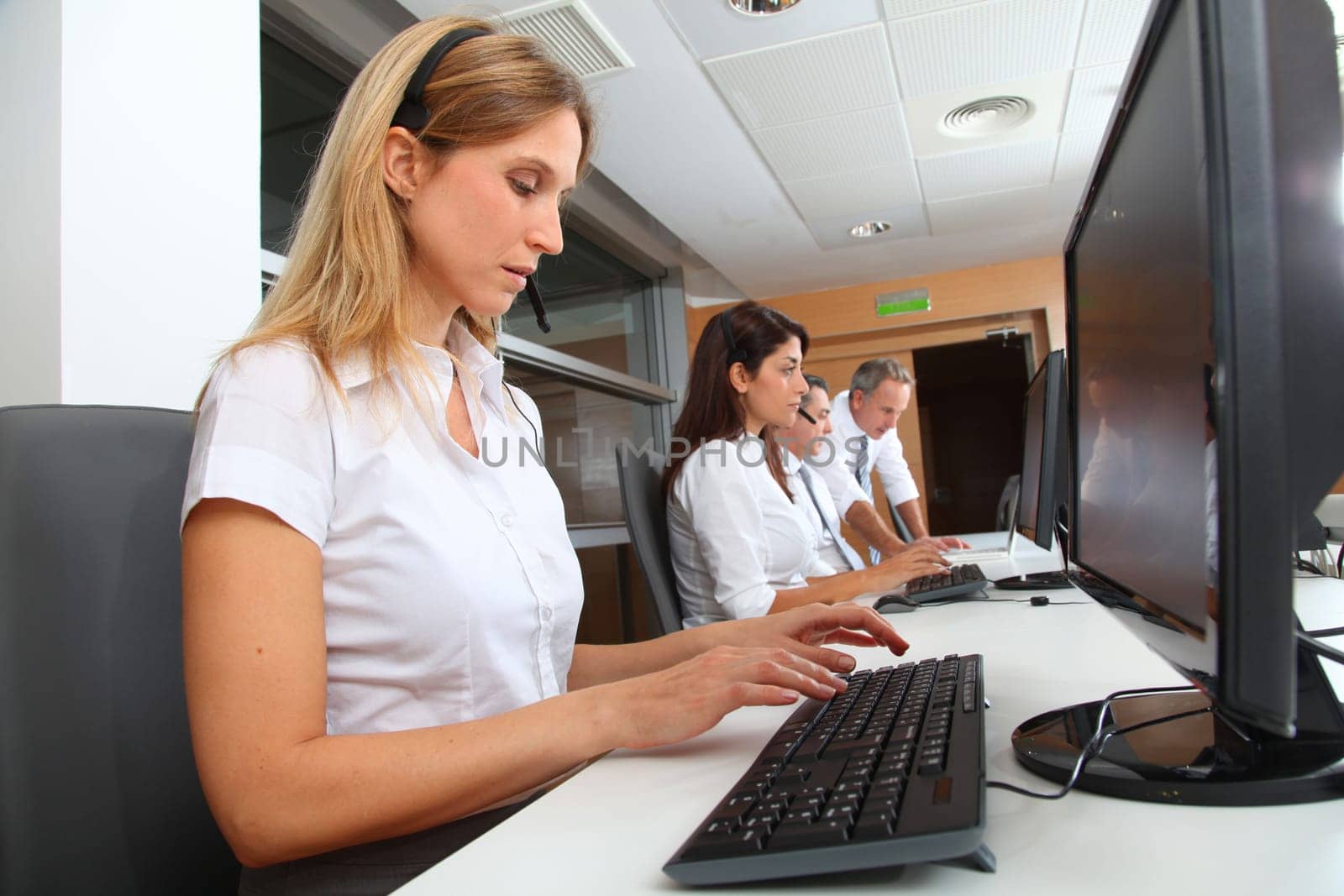 Blond businesswoman with headset on