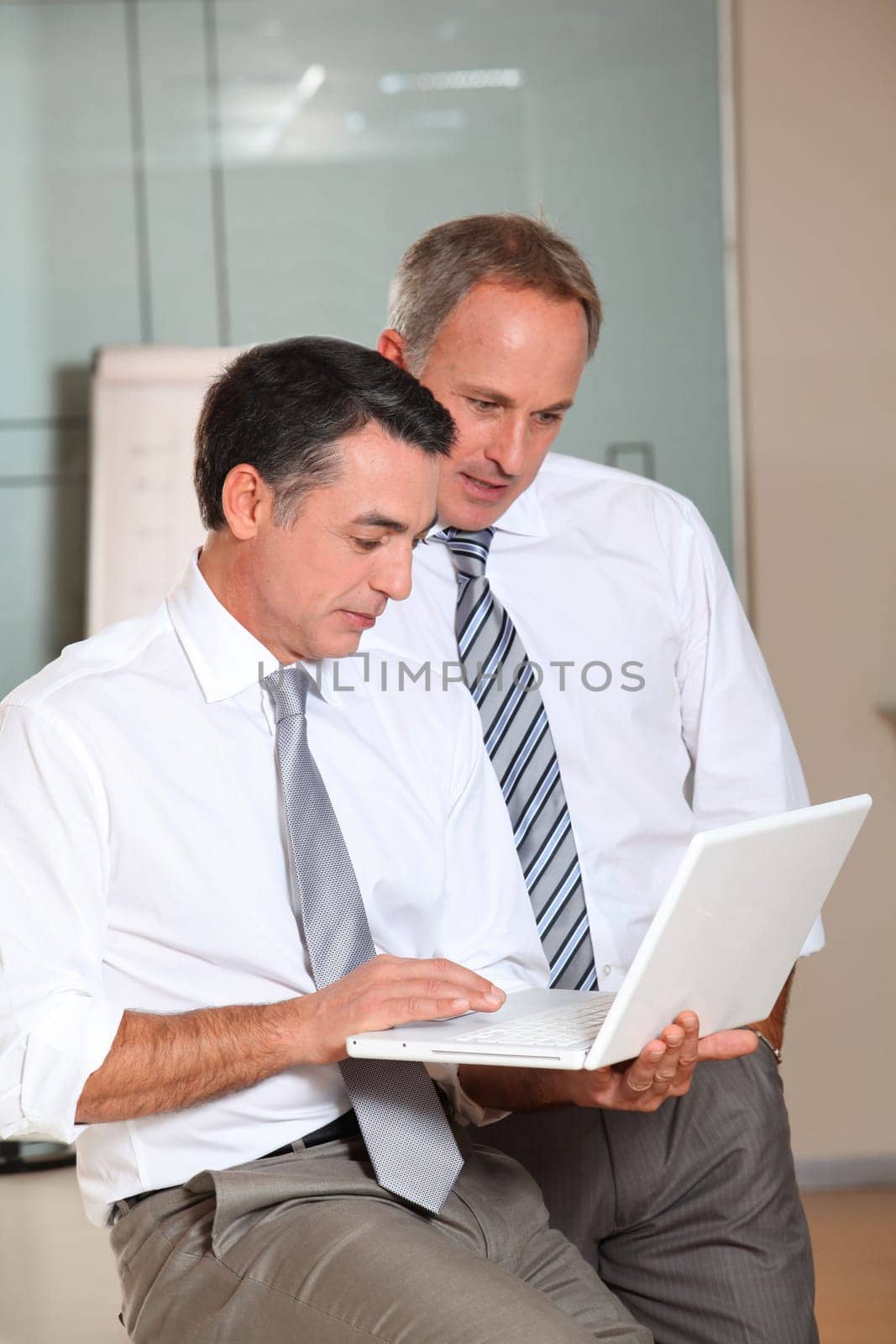 Salesmen meeting in the office with laptop