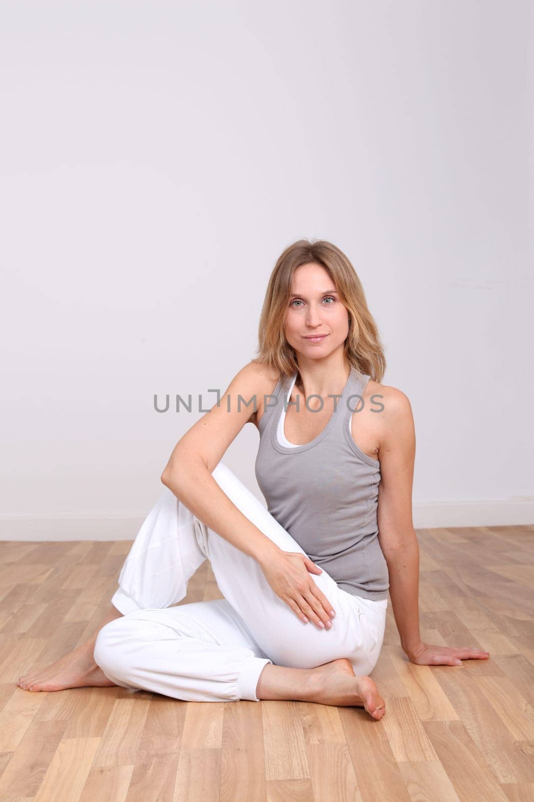 Blond woman doing yoga exercises