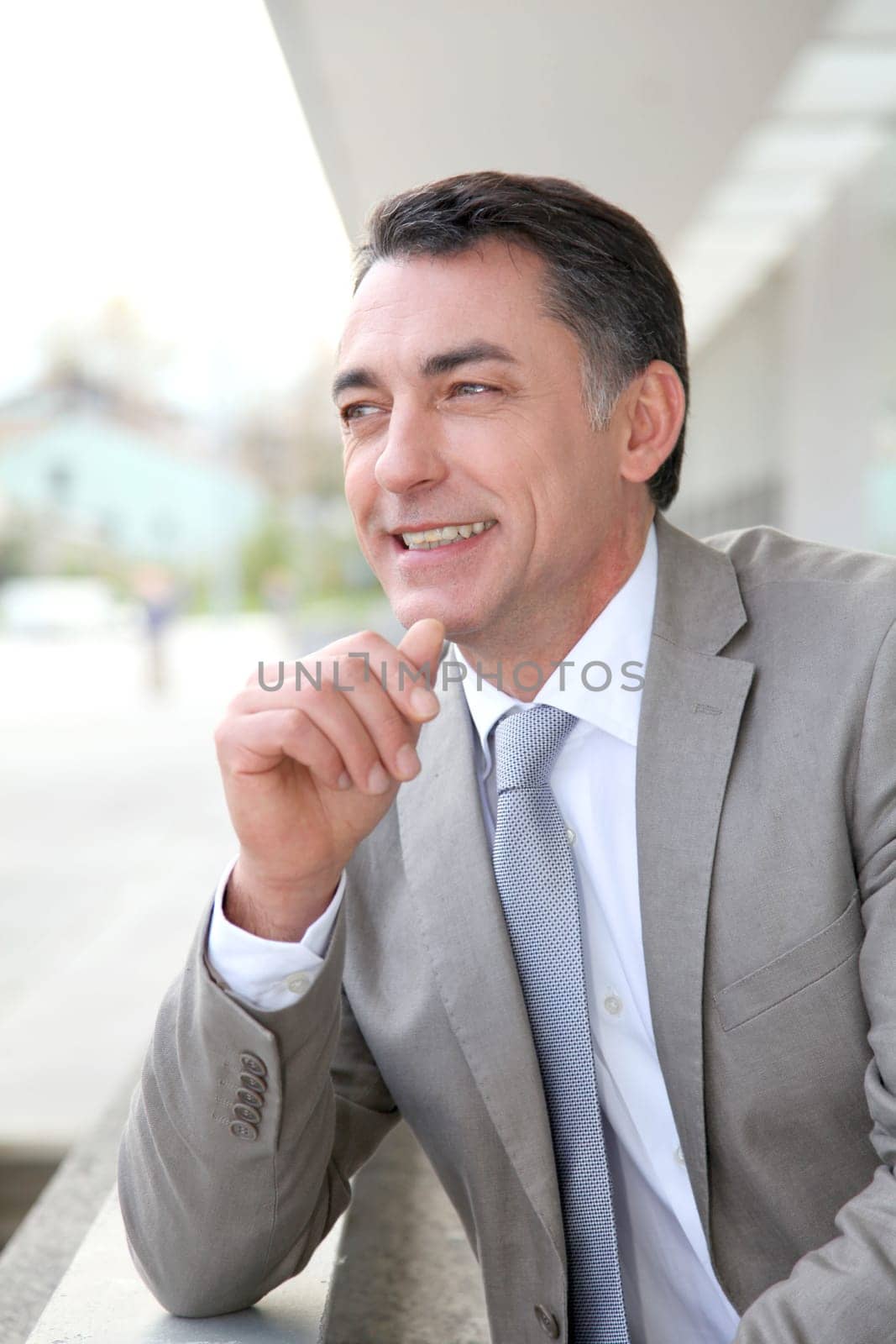 Businessman standing outside modern building