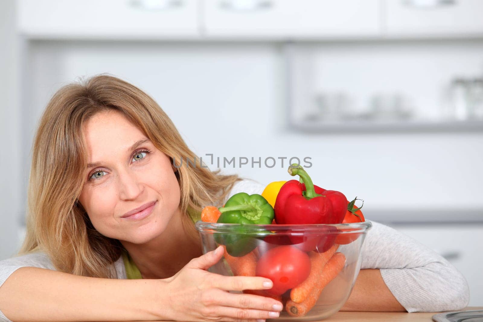 Woman in kitchen ready to prepare meal with vegetables