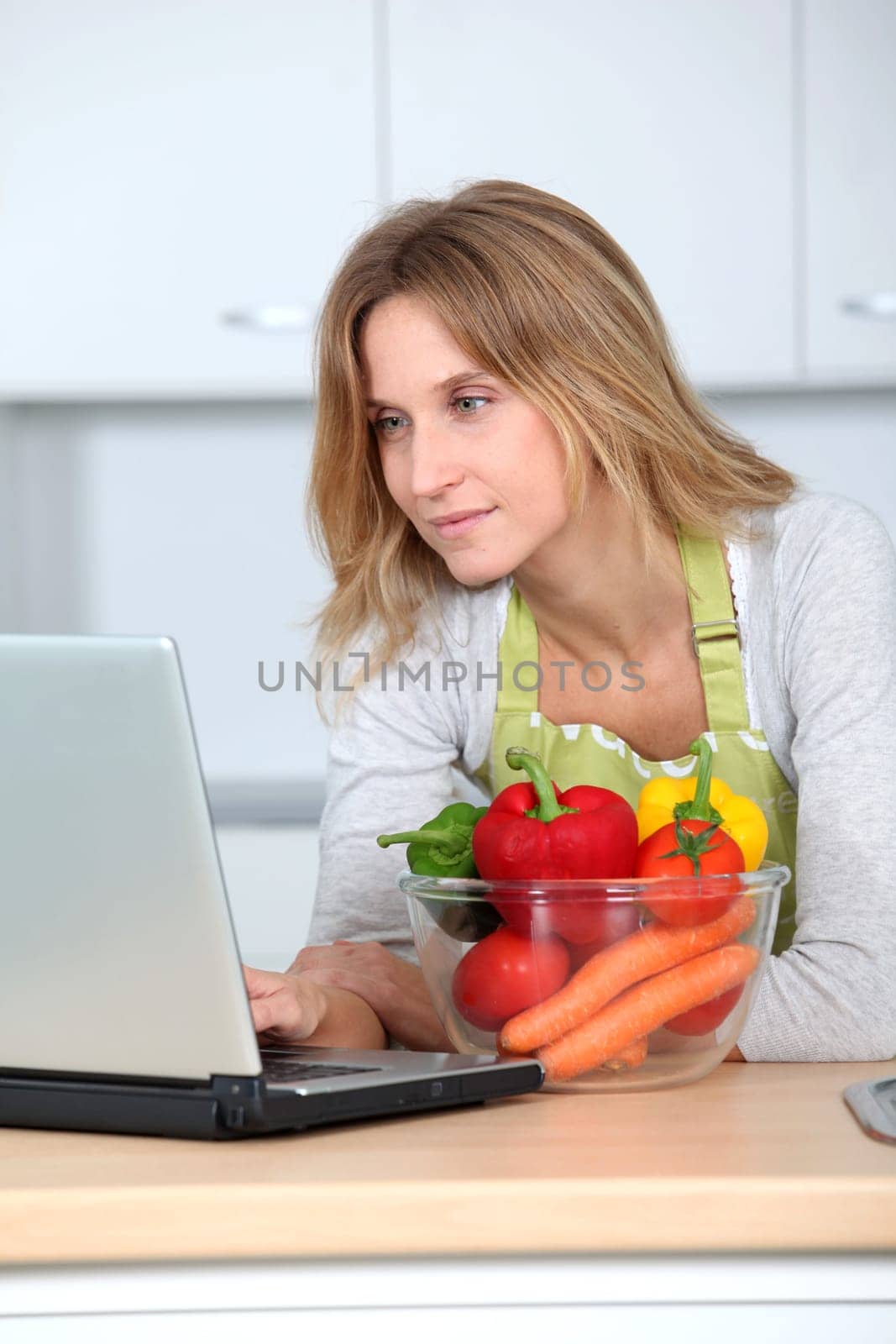 Woman in kitchen looking for cooking receipe