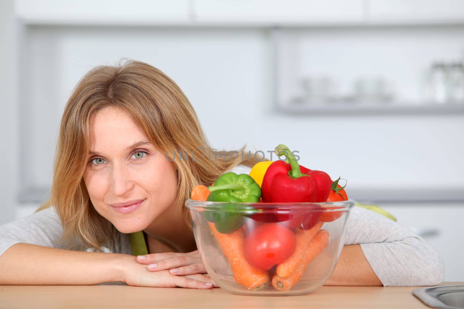 Woman in kitchen ready to prepare meal with vegetables
