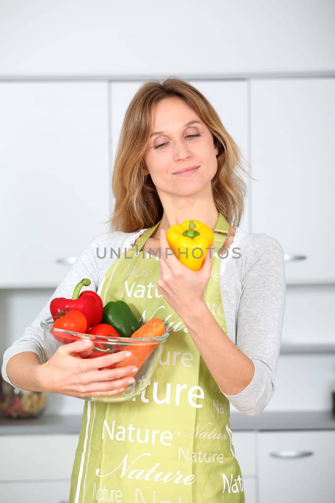 Woman in kitchen ready to prepare meal with vegetables
