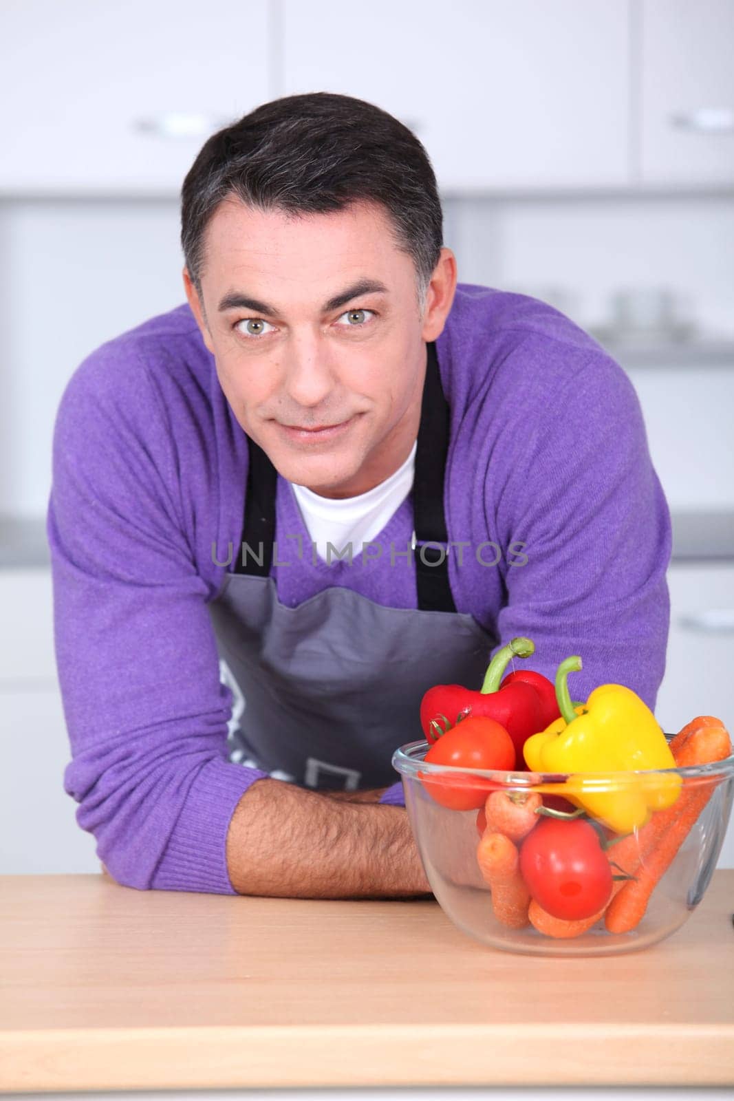 Man in kitchen with laptop computer