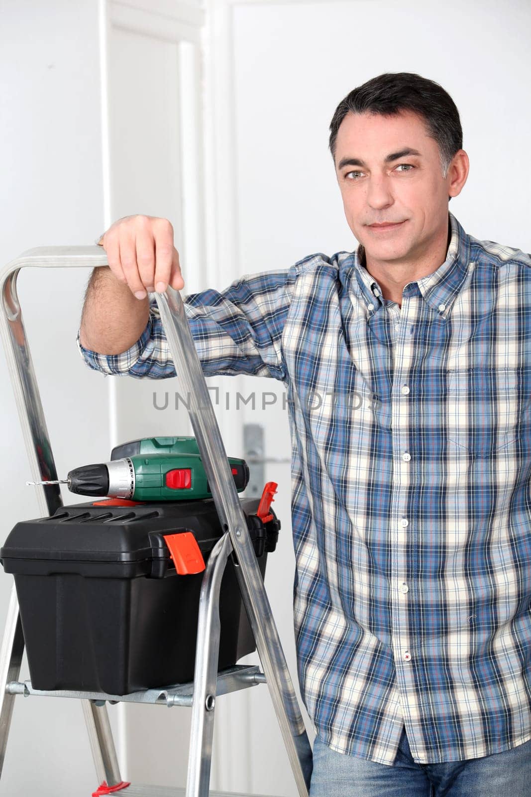 Man using electric drill at home