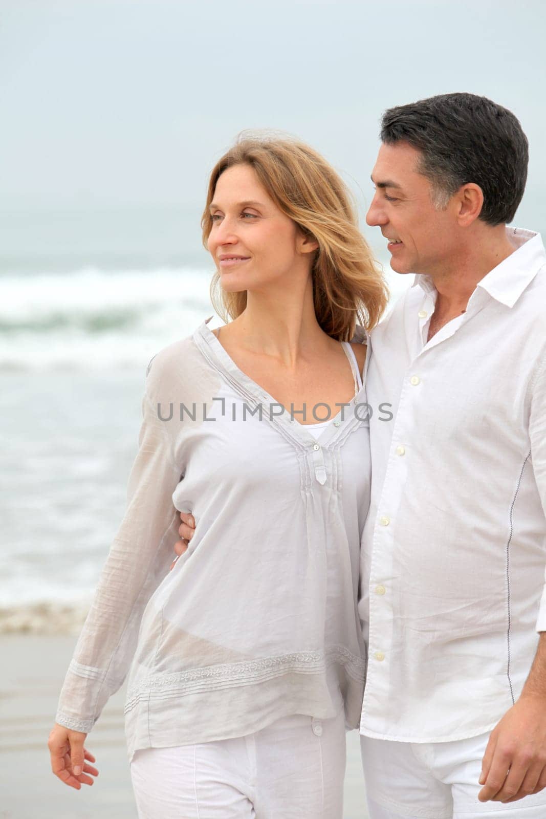 Couple walking by the beach