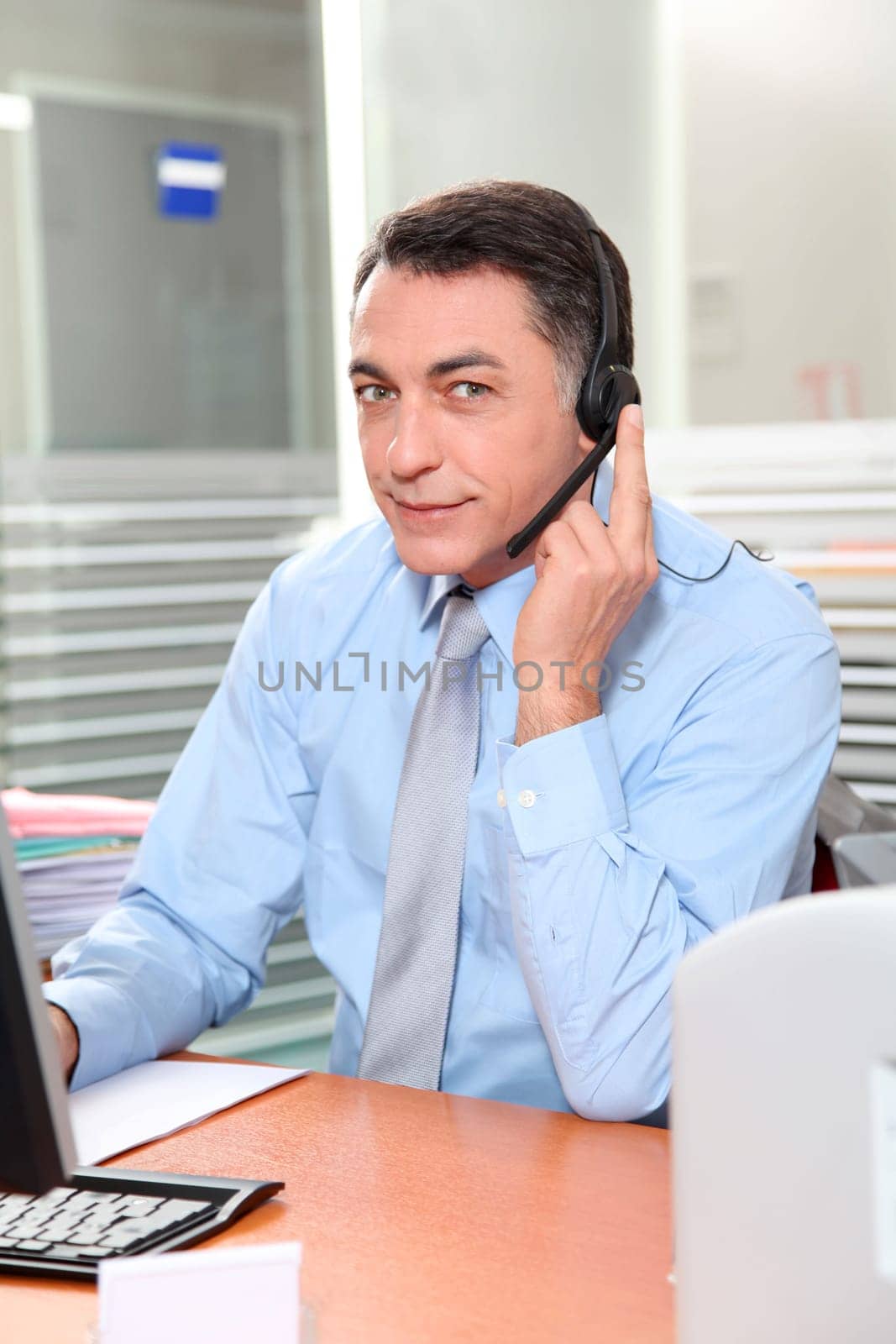 Adult man in the office talking on the phone