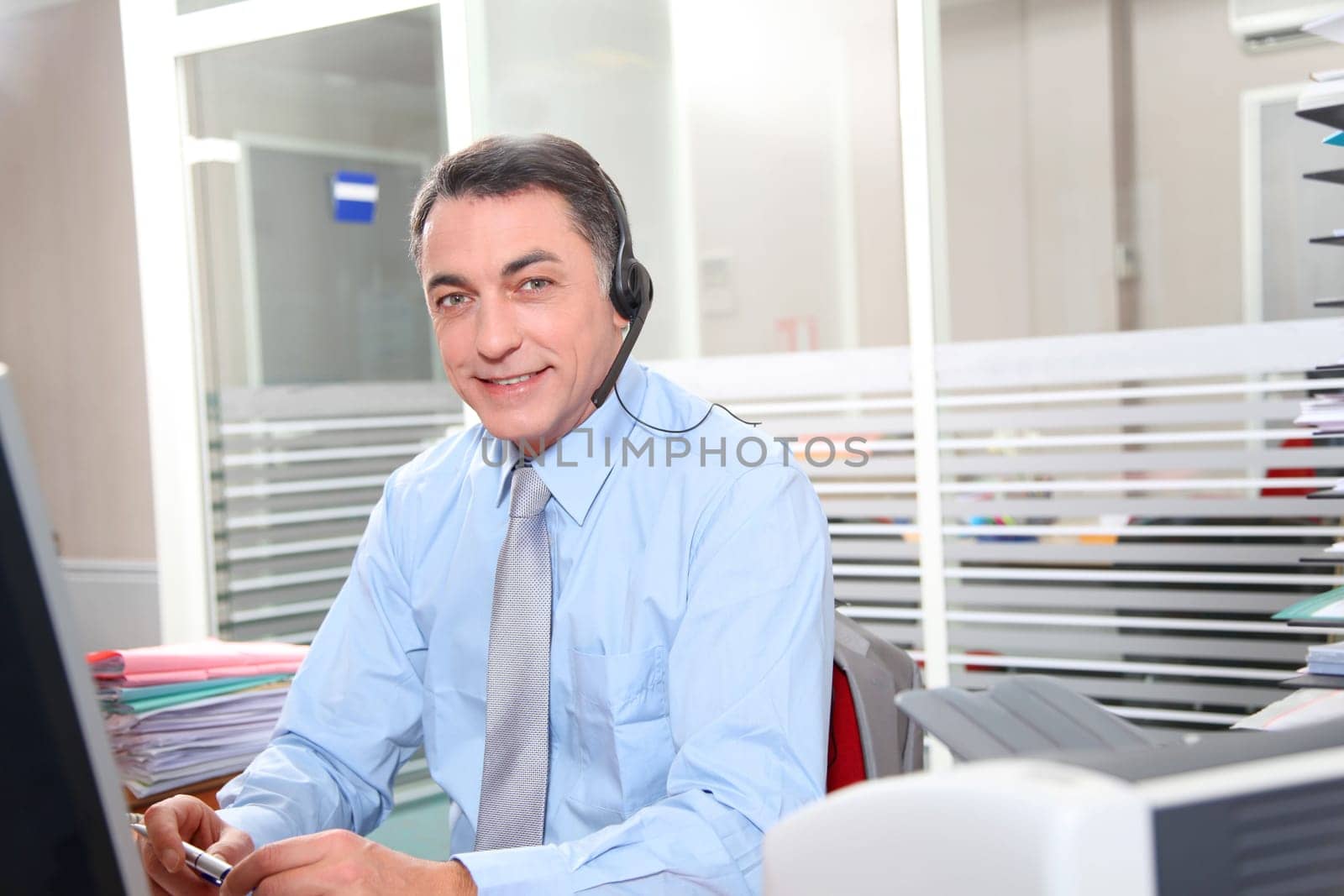Adult man in the office talking on the phone