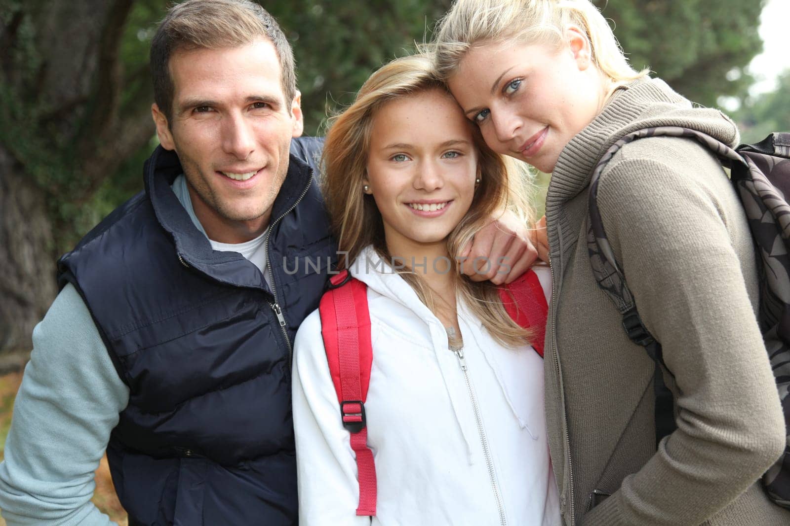 Parents and daughter walking in the countryside