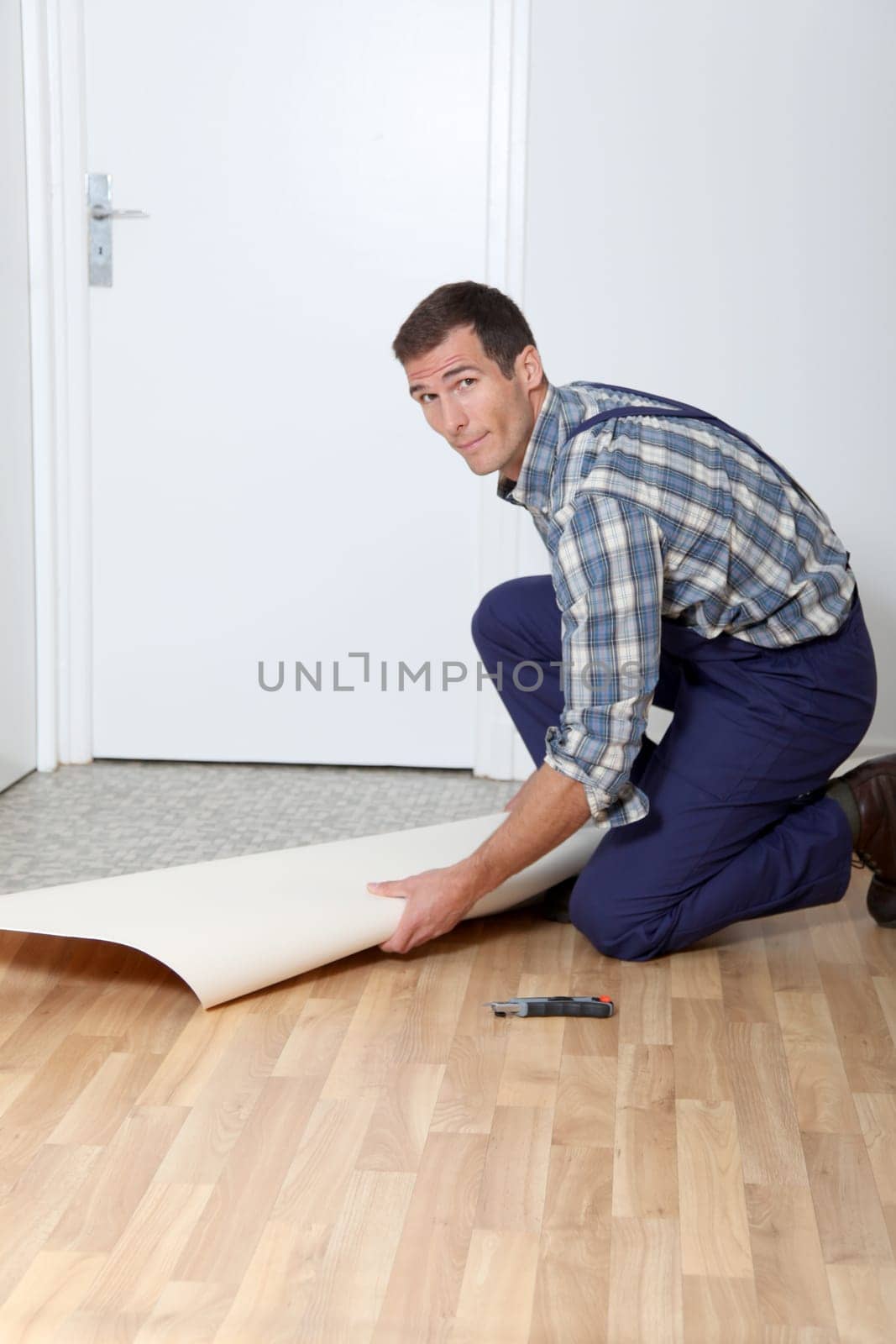 Closeup of artisan installing ground floor in room