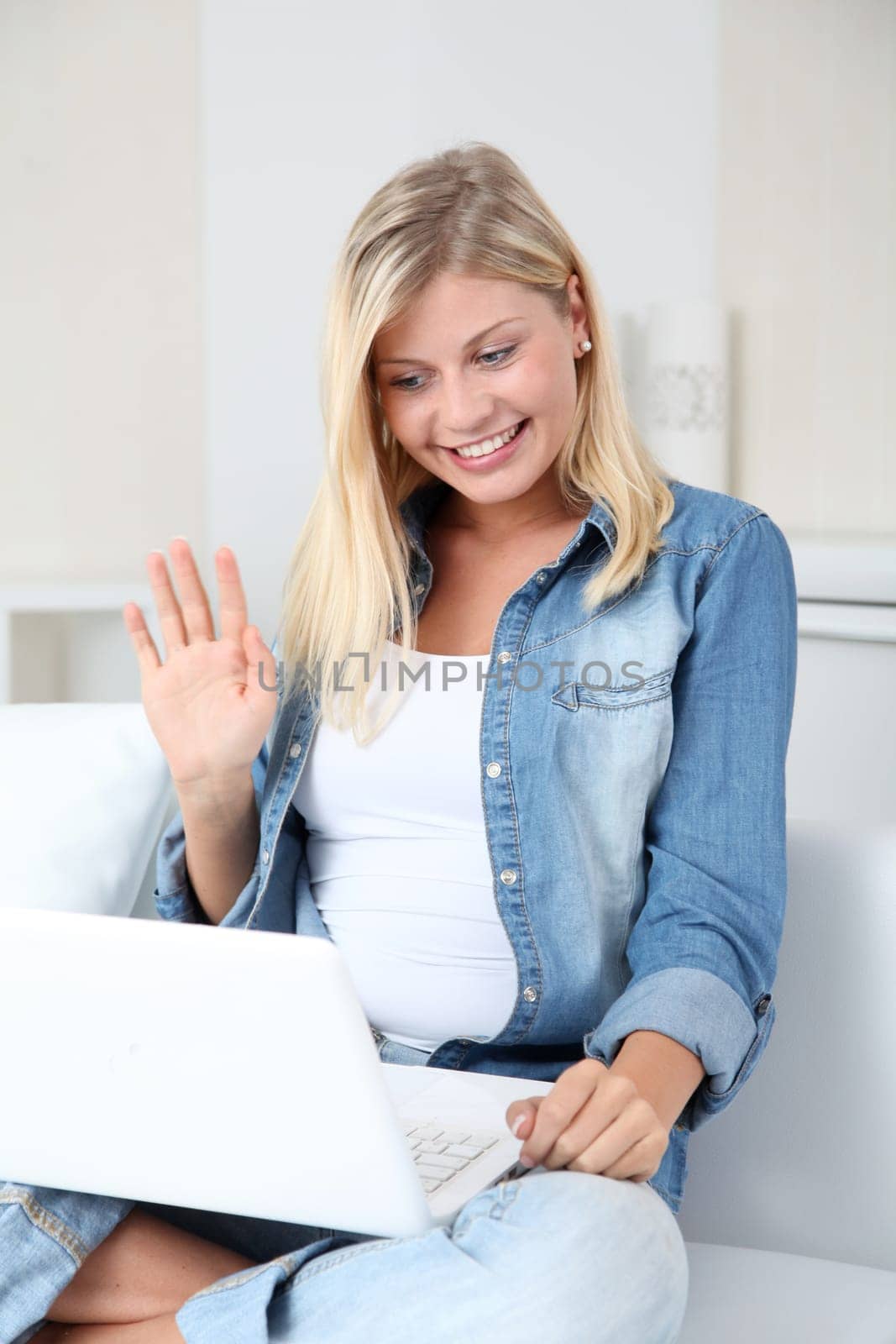 Beautiful blond woman chating on internet with web camera