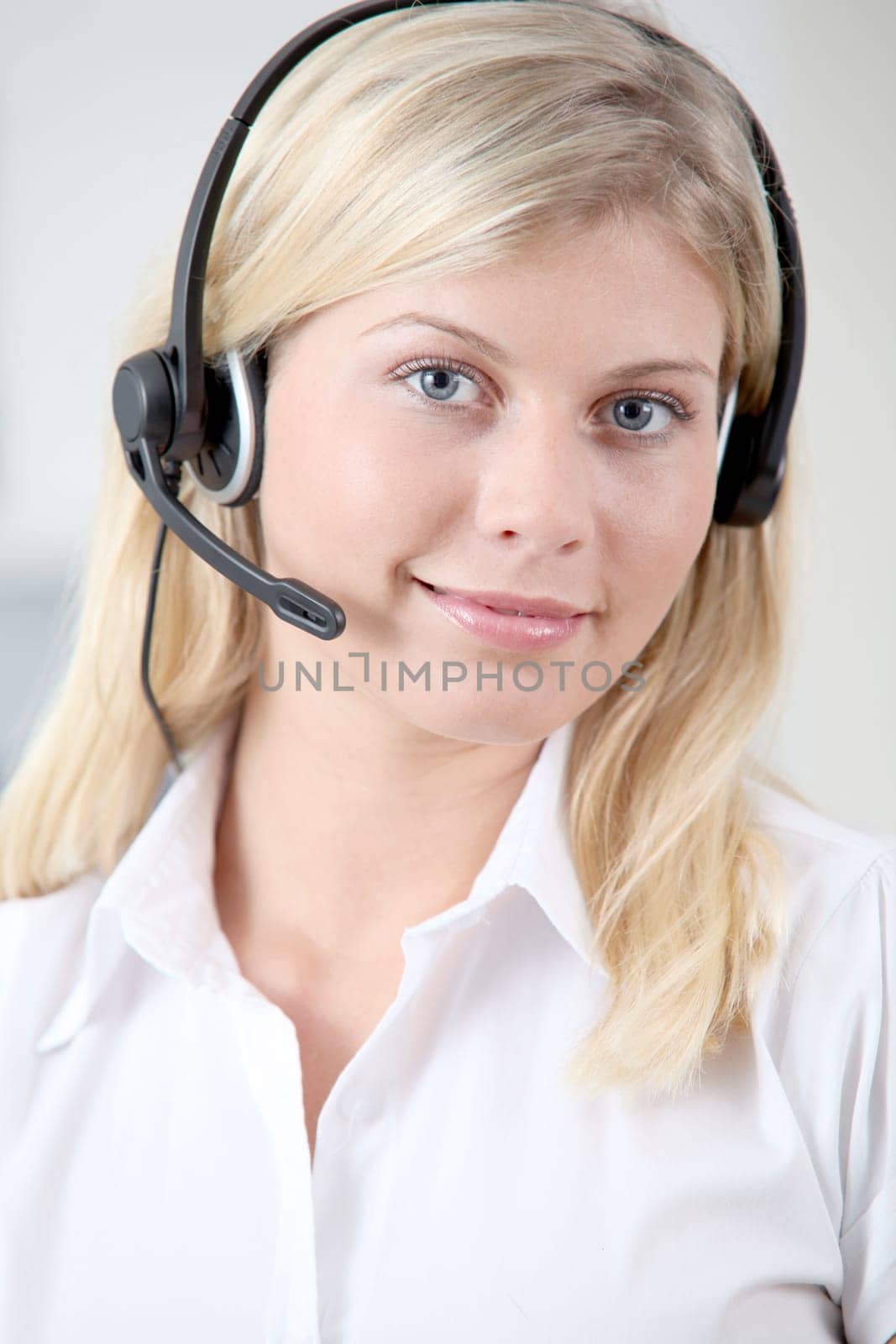 Closeup of blond woman with headphones and microphone