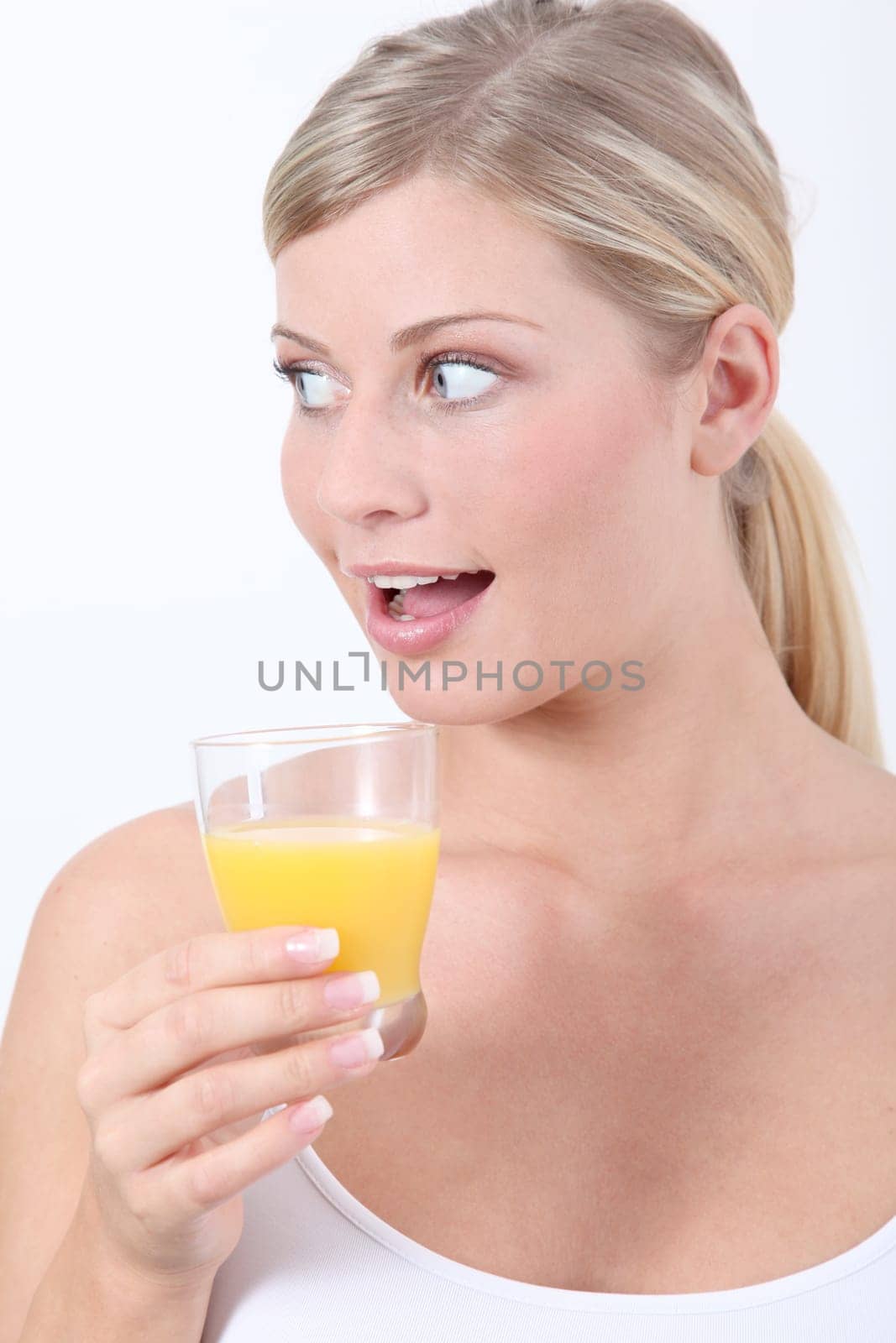 Beautiful blond woman holding glass of orange juice