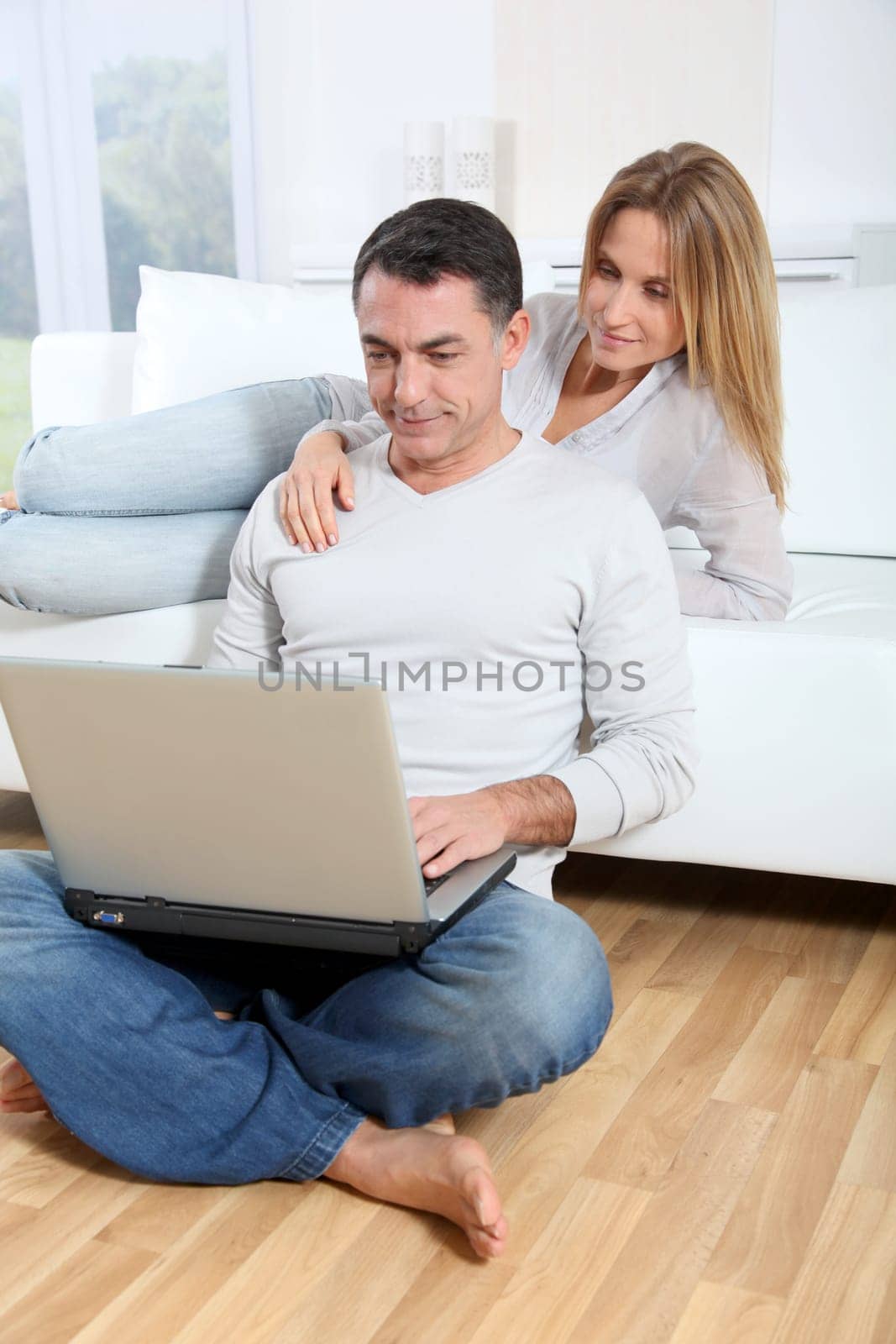 Happy couple surfing on internet at home