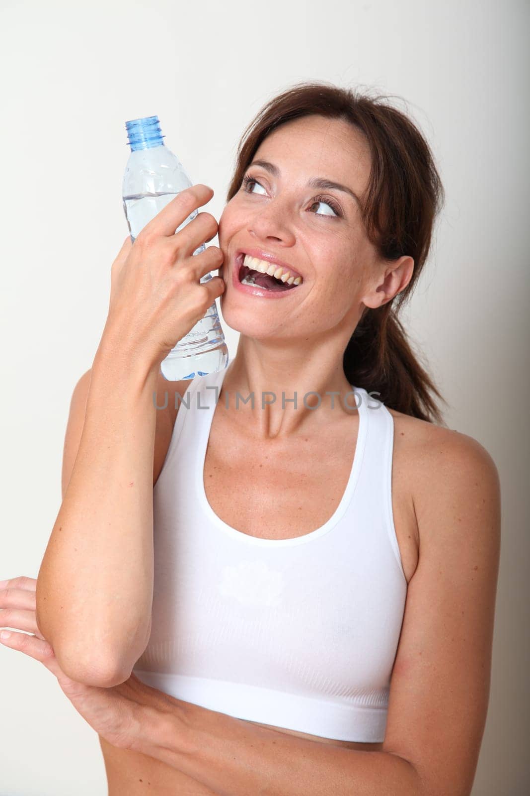 Closeup of woman drinking water after exercising