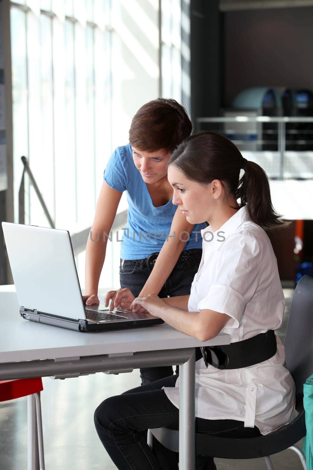 Young women working on laptop computer