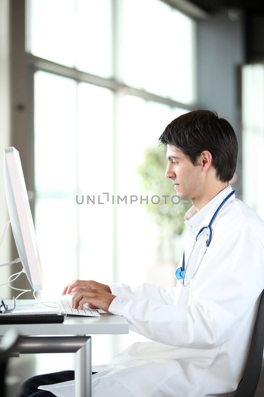 Young doctor working in front of computer