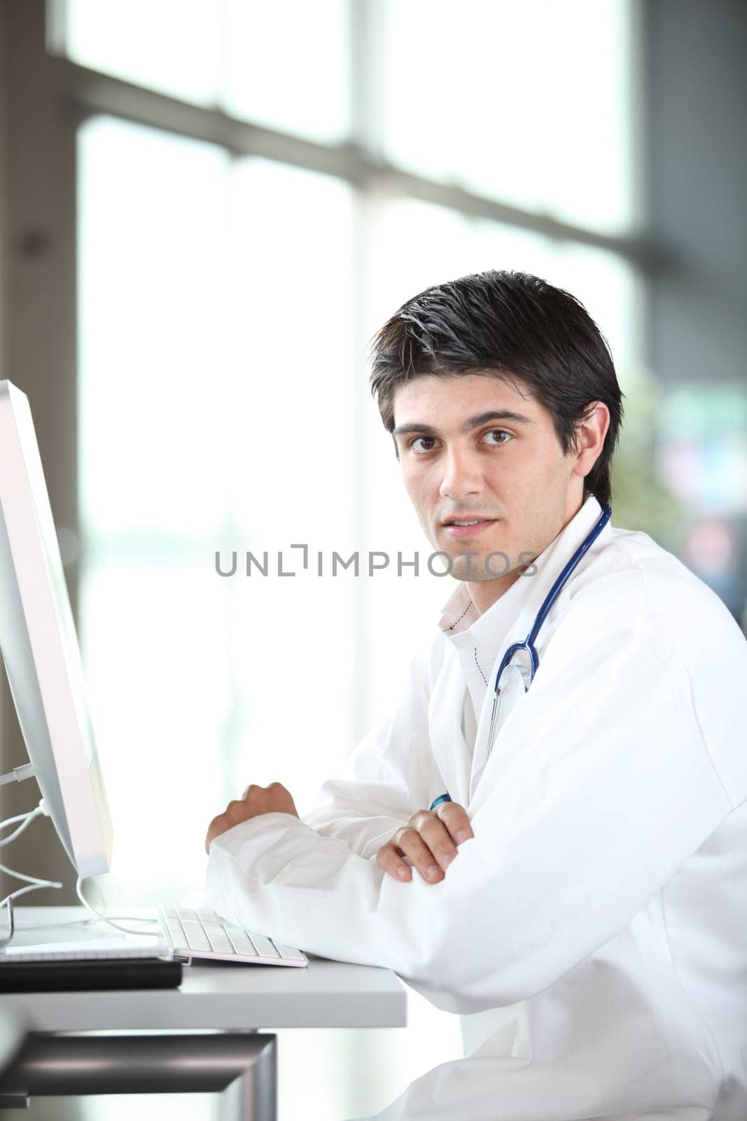 Young doctor working in front of computer