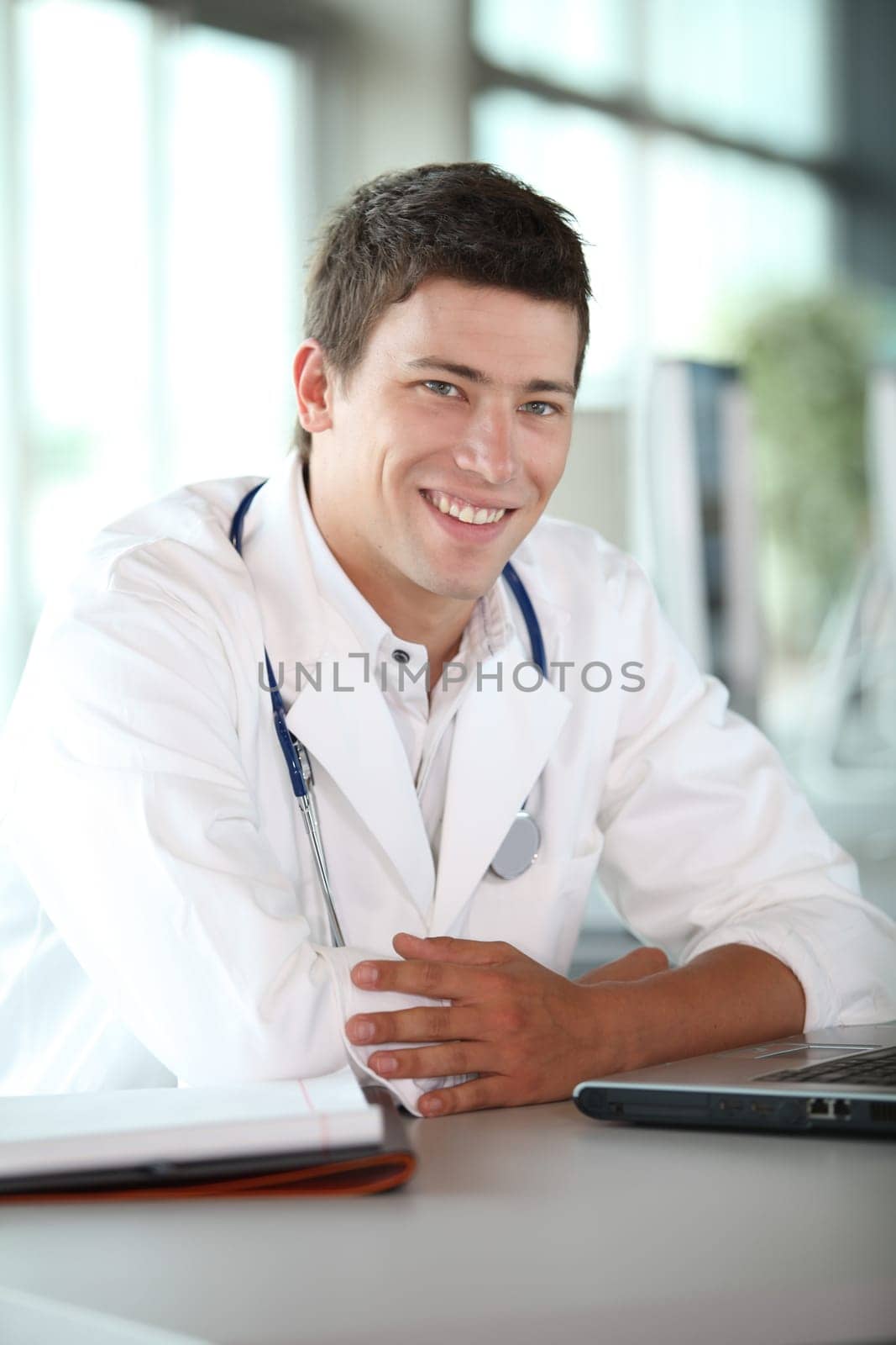 Young doctor in front of laptop computer