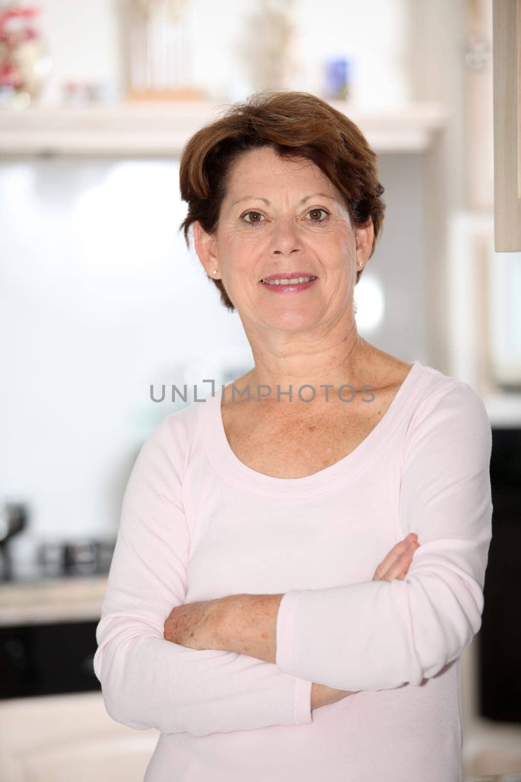 Closeup of senior woman standing in kitchen